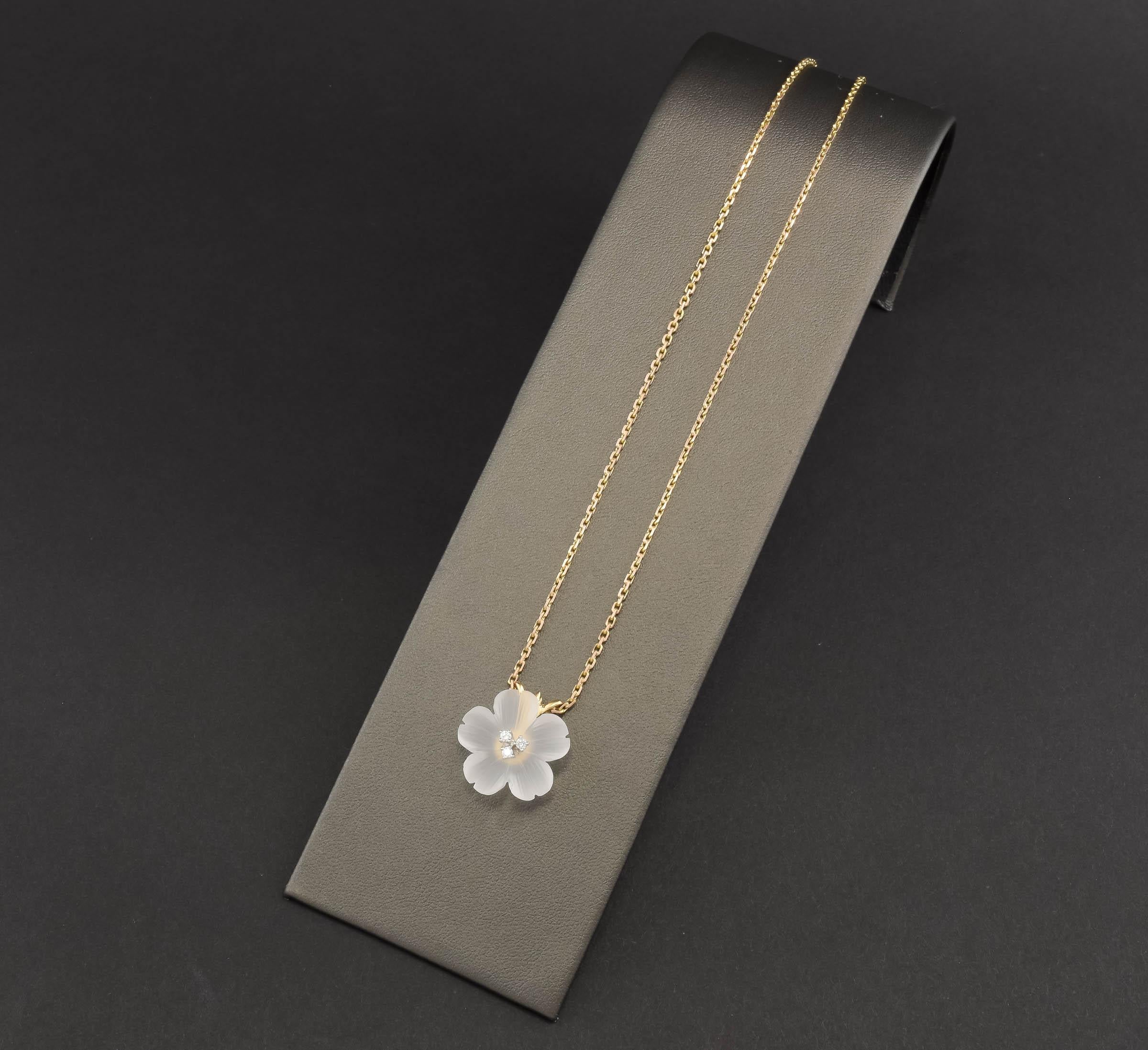 Offered is a lovely mid-century pendant by esteemed NYC jeweler Baumstein & Feder - featuring an elegant hand carved rock crystal flower blossom set with fiery diamonds, suspended from a vintage gold chain.

Measuring a little over 3/4 of an inch in