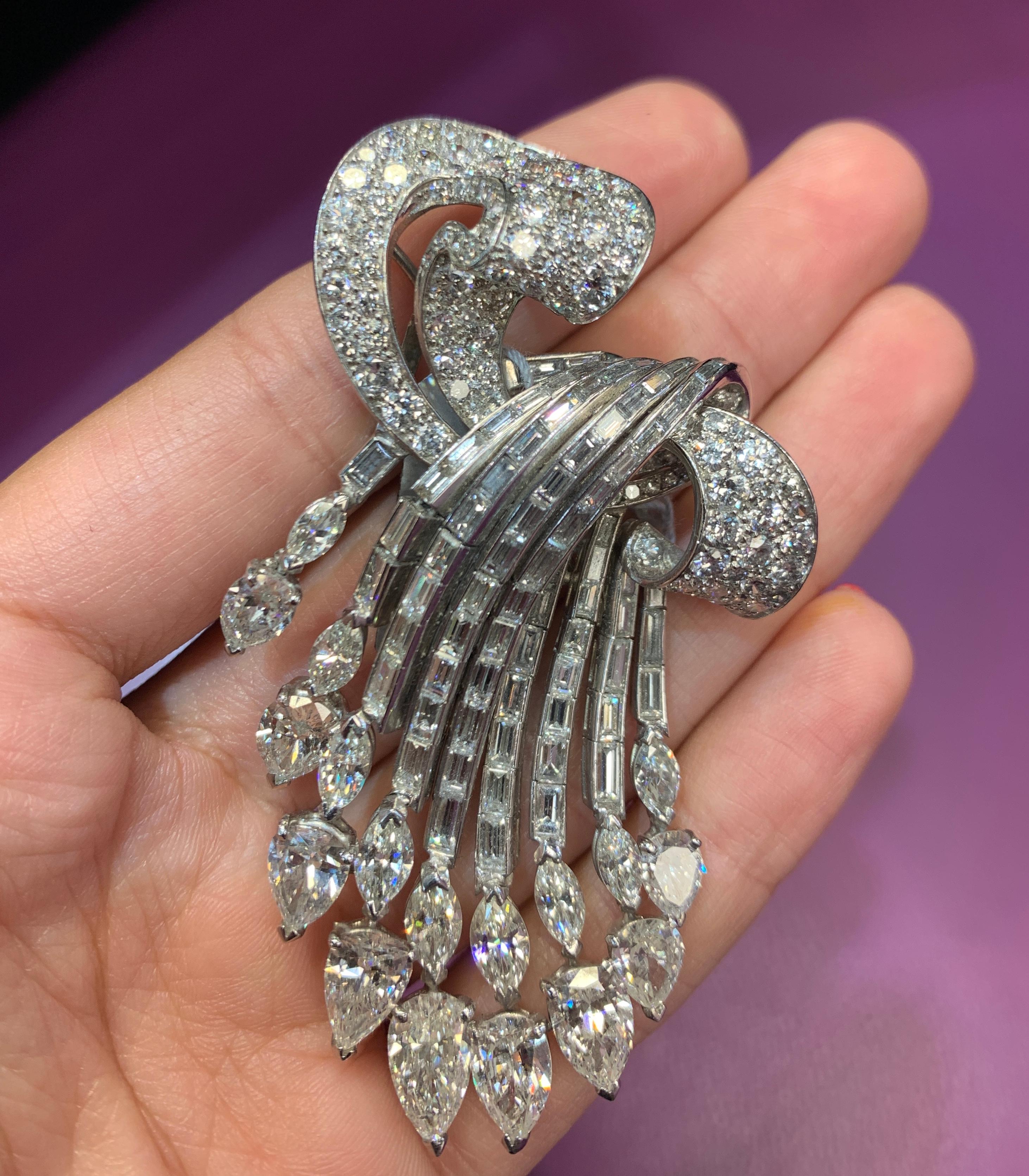 Diamond Cascade Brooch, Set in 18K White Gold consisting of  Nine pear shape diamonds totaling 8.35 carats, marquise cut diamonds 2.68 carats, 77 baguettes totaling 4.40 carats & 105 round cut diamonds totaling 3.90 carats.
Approx Measurements: 2.5