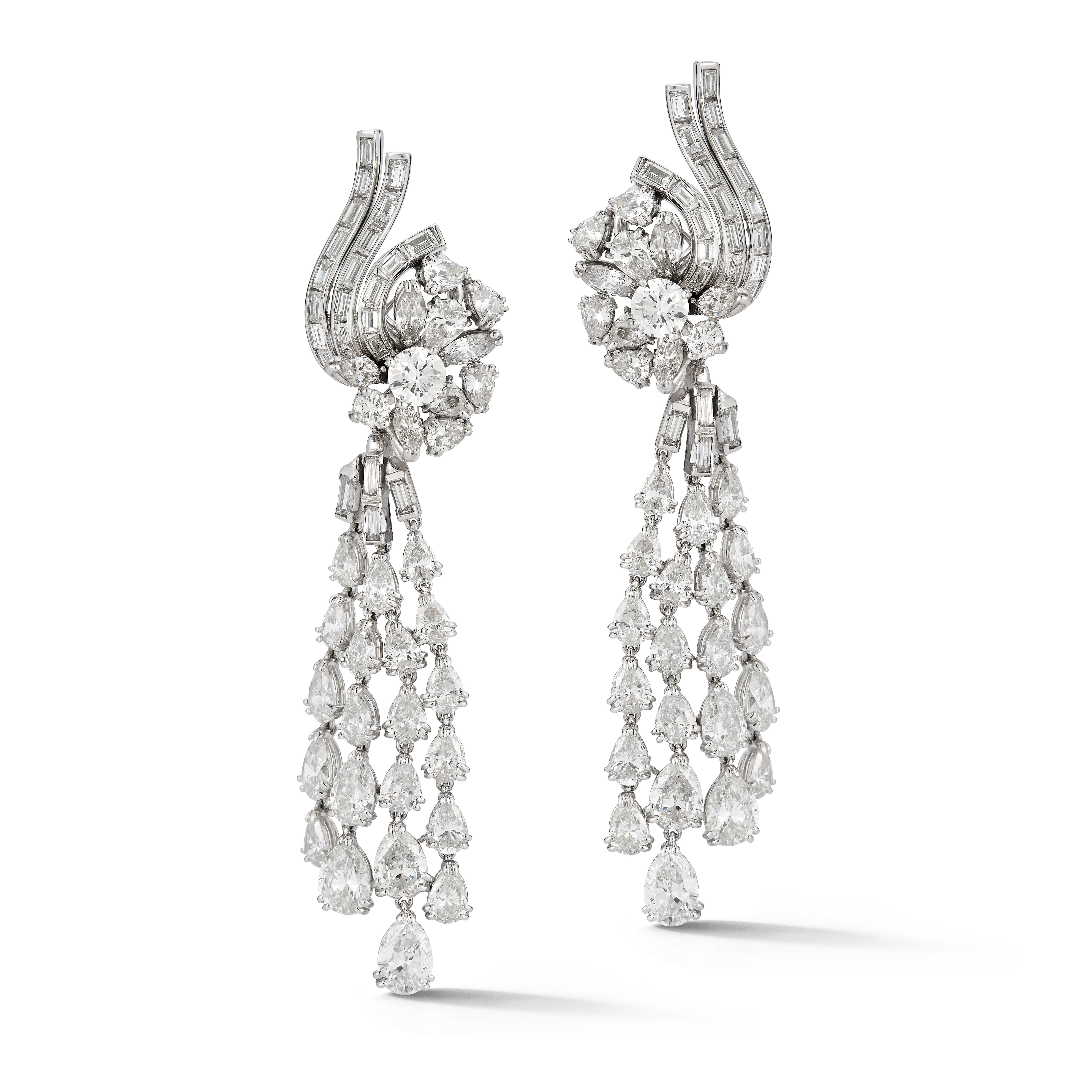 Diamond Cascade Day & Night Chandelier Earrings

A pair of platinum earrings set with 54 pear shaped diamonds, 48 baguette cut diamonds, 8 marquise cut diamonds, and 4 round cut diamonds. The cascading pear shaped diamonds are a removable attachment