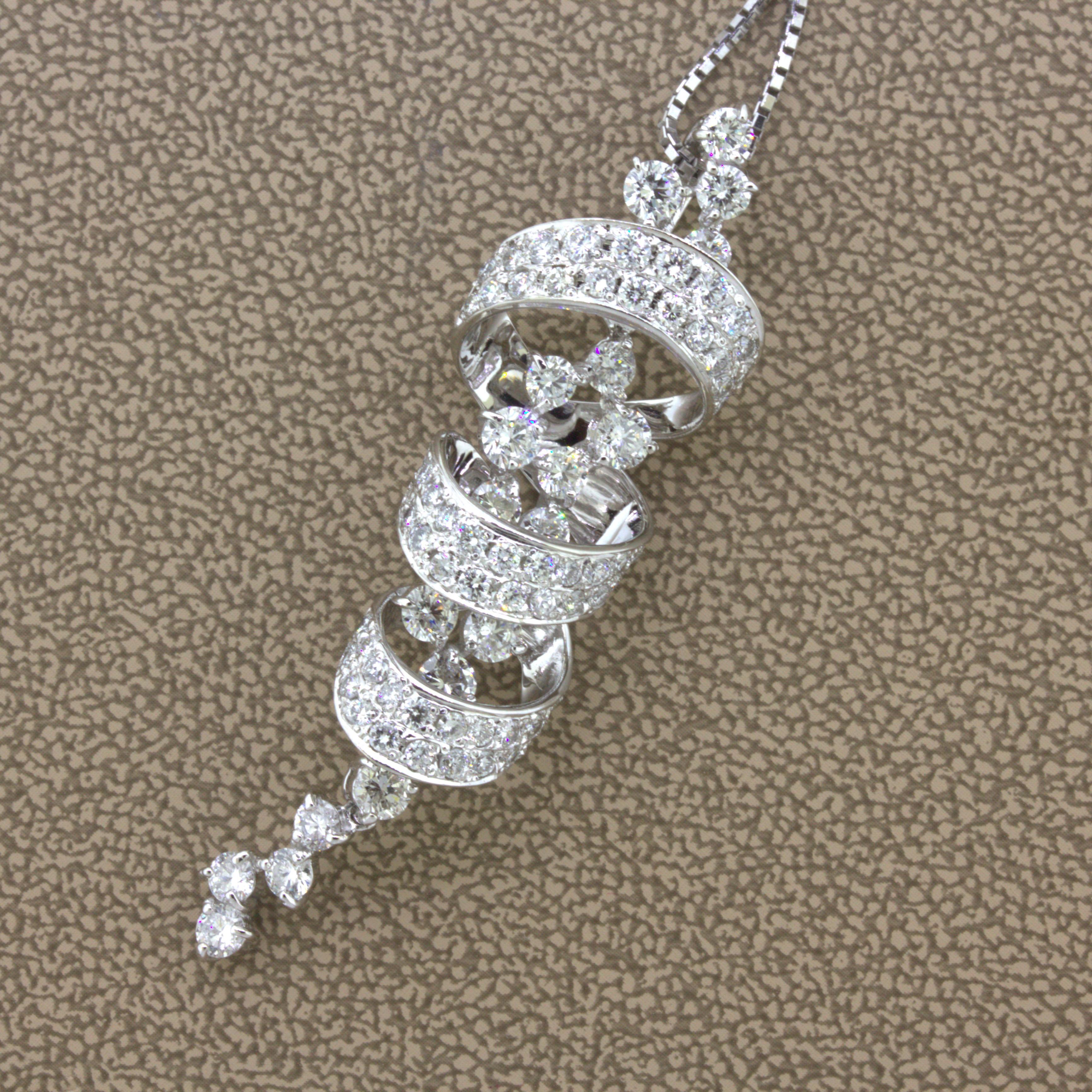 A chic and elegant diamond pendant featuring a cascade of fine round brilliant-cut diamonds. They weigh a total of 3.04 carats and drop town the pendant as well as wrap around portions of it creating a waterfall design. The diamonds are all bright