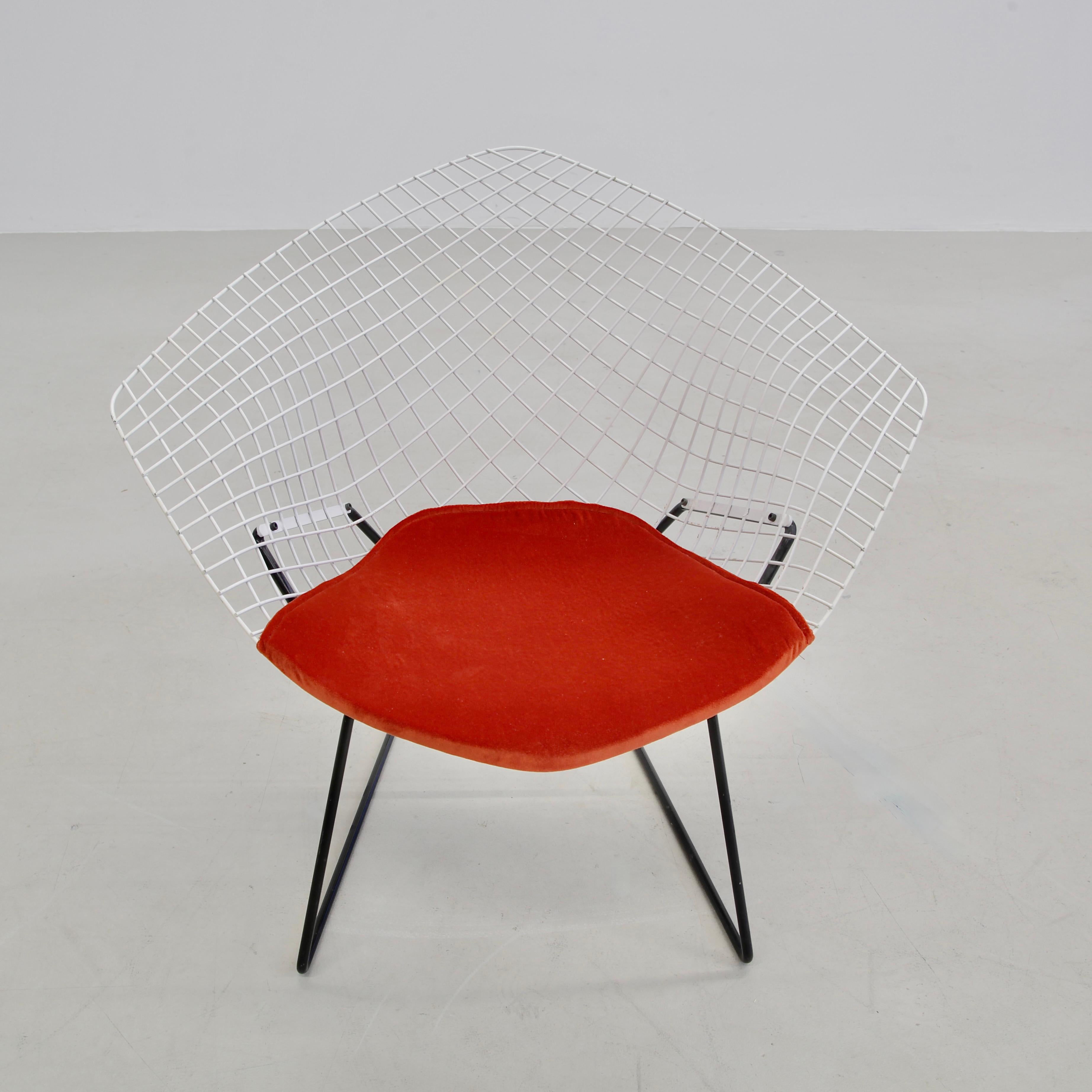 Original Diamond Chairs, designed by Harry Bertoia. U.S.A., Knoll International, 1970s

Early production Diamond chairs in white and black painted metal with rust-orange velvet pads.

The Bertoia Diamond Armchair, originally designed in 1952 is one