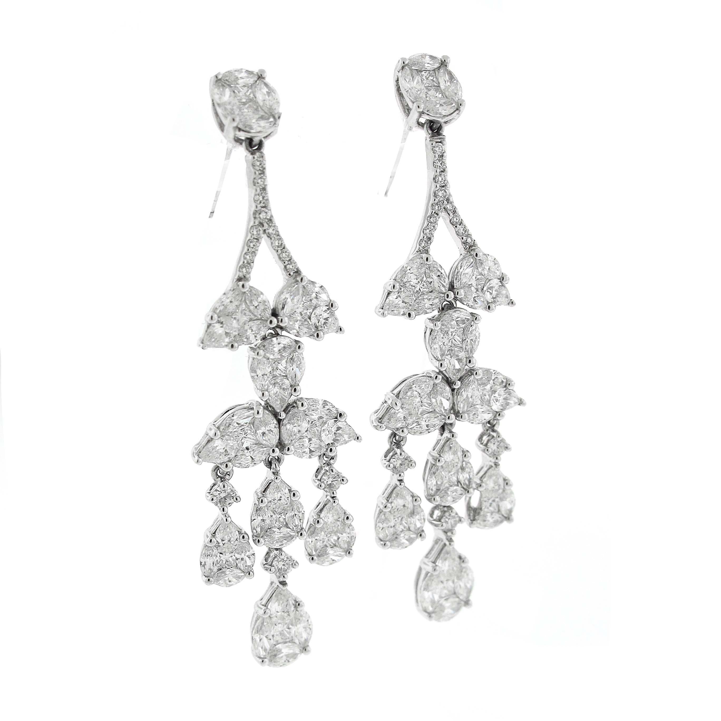 Fantastic looking pair of diamond chandelier earrings. These are clusters of diamonds, rather than individual diamonds. The craftsmanship is so well that it looks like a single stone, but is much less expensive. They are high quality, white diamonds