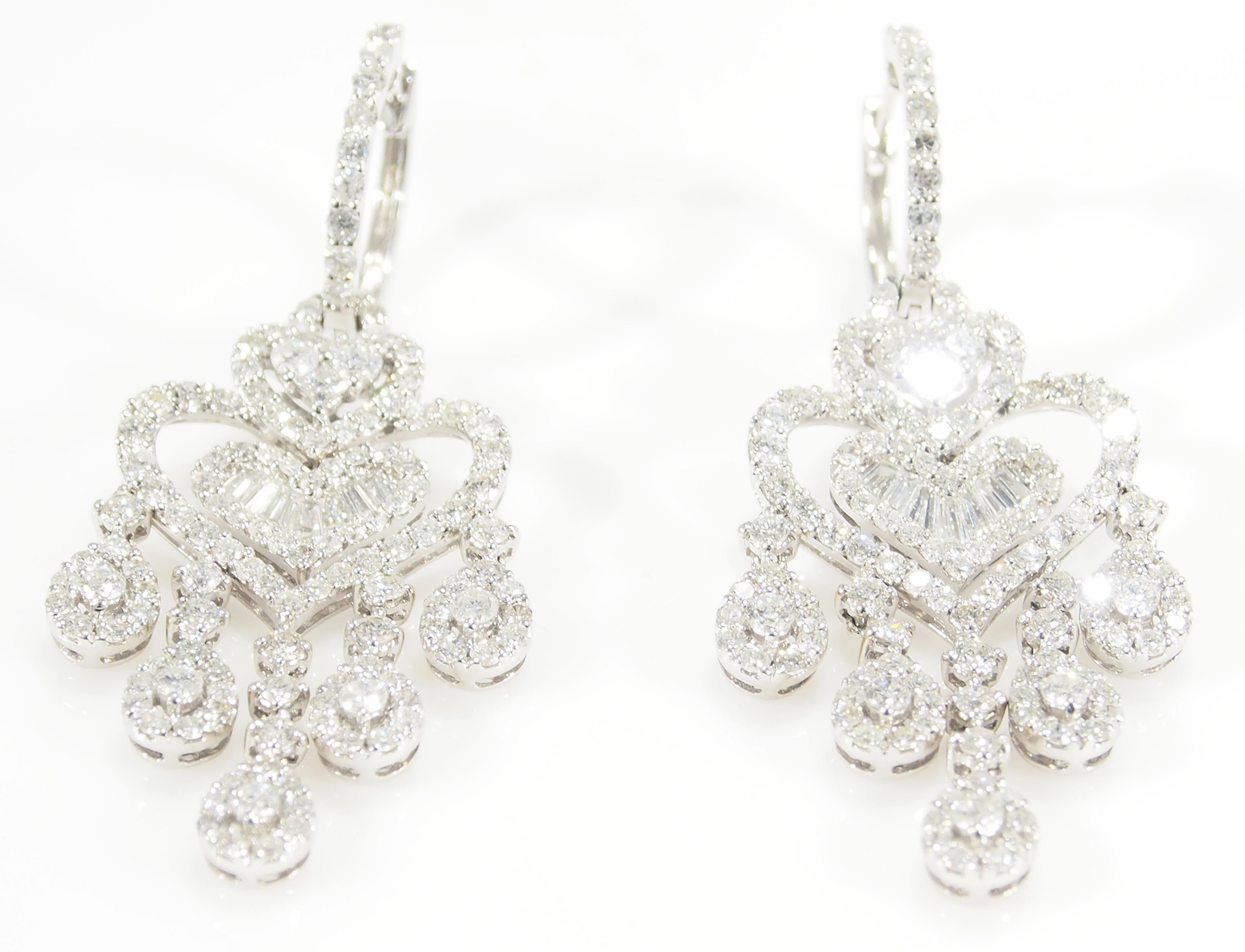 These are stunning 18 Karat White Gold Diamond Chandelier Earrings. From a Diamond Hoop top are dangling Heart Shapes and Pear Shapes Drops created from 282 Round Brilliant Cut Diamonds and Baguette Diamonds, G-H in Color, VS-SI in Clarity for an