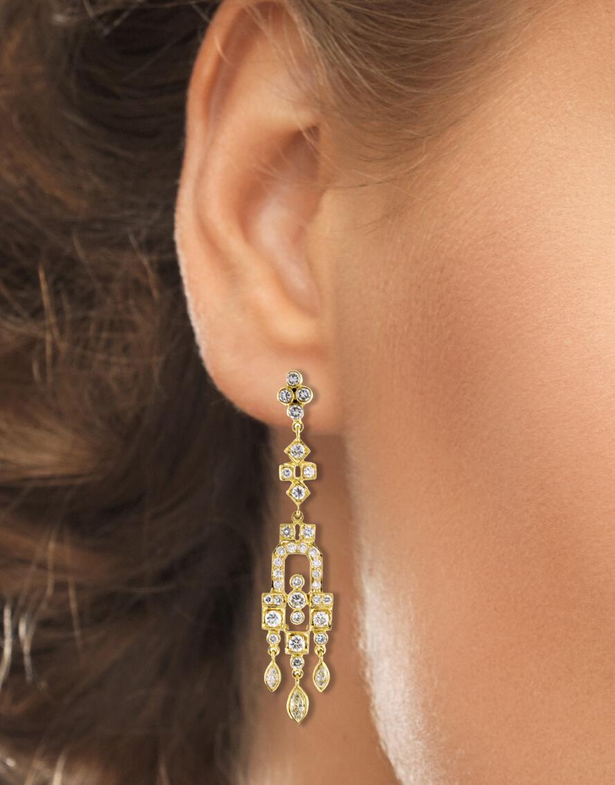 These 18kt yellow gold earrings have 6 marquise diamonds and 64 round diamonds.
• Metal: 18kt Yellow Gold	
• Circa: 21st Century
• Gemstone: 6 marquise diamonds=.40 carats
		     64 round diamonds=.96 carats
• Weight: 13.1 grams
• Dimensions: 2