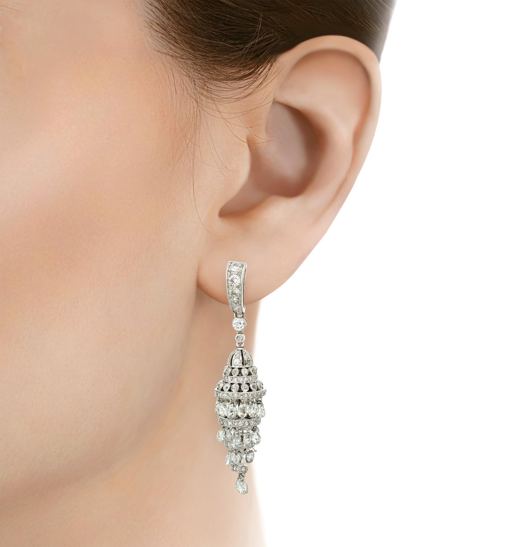 Both elegant and architectural in design, these chandelier earrings offer bountiful brilliance. Approximately 10.00 carats of cascading white diamonds form the creations. The shine of the diamonds is perfectly matched by their 14K white gold