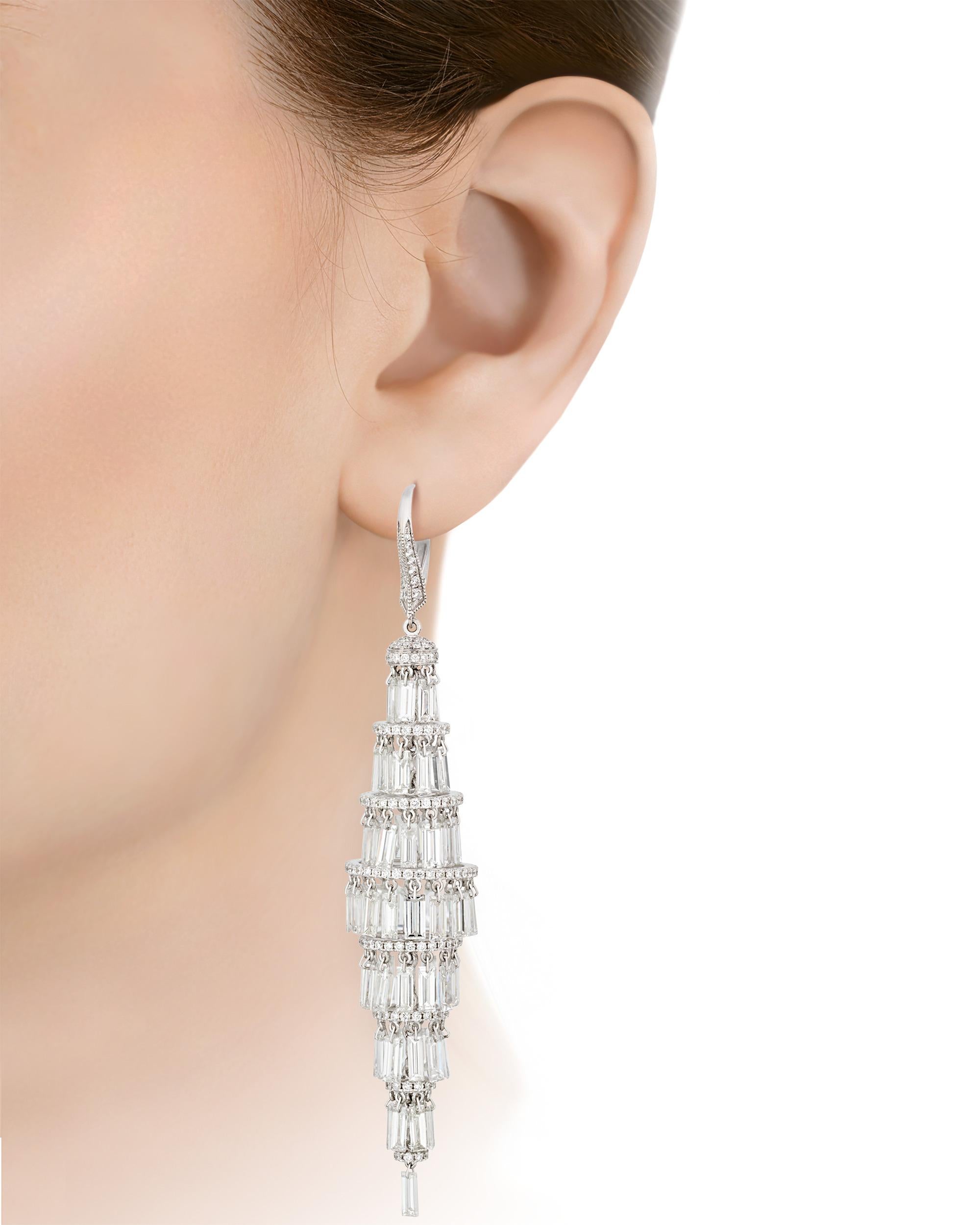 Both elegant and architectural in design, these chandelier earrings offer bountiful brilliance. Nearly 23.00 carats of cascading white baguette diamonds form the creations. The shine of the diamonds is perfectly matched by the 18K white gold