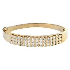 Diamond channel set 14k yellow gold bangle bracelet 
