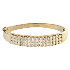 Diamond channel set 14k yellow gold bangle bracelet