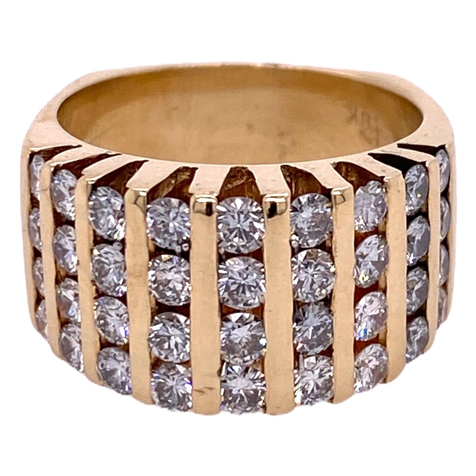Beautiful diamond channel set band fashioned in 18 karat yellow gold. The band features 36 round brilliant cut diamonds weighing 2.00 carat total weight and graded G-H color and VS2-SI1 clarity. The band measures 10.7mm in width and is currently