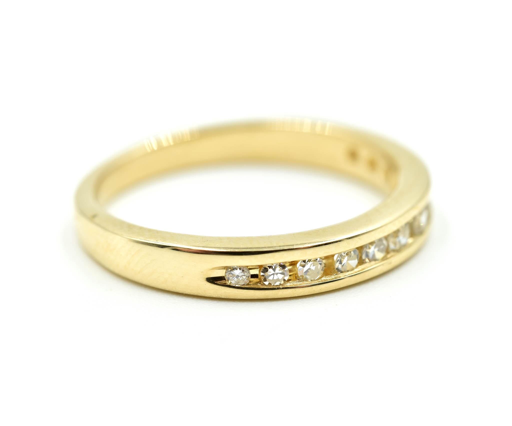 Designer: custom design
Material: 14k yellow gold
Diamonds: 12 round brilliant cuts = 0.26 carat total weight
Color: H
Clarity: VS2-SI1
Dimensions: top of ring is 3.27mm long and 21.63mm wide
Ring size: 7 ¾ 
Weight: 3.06 grams

