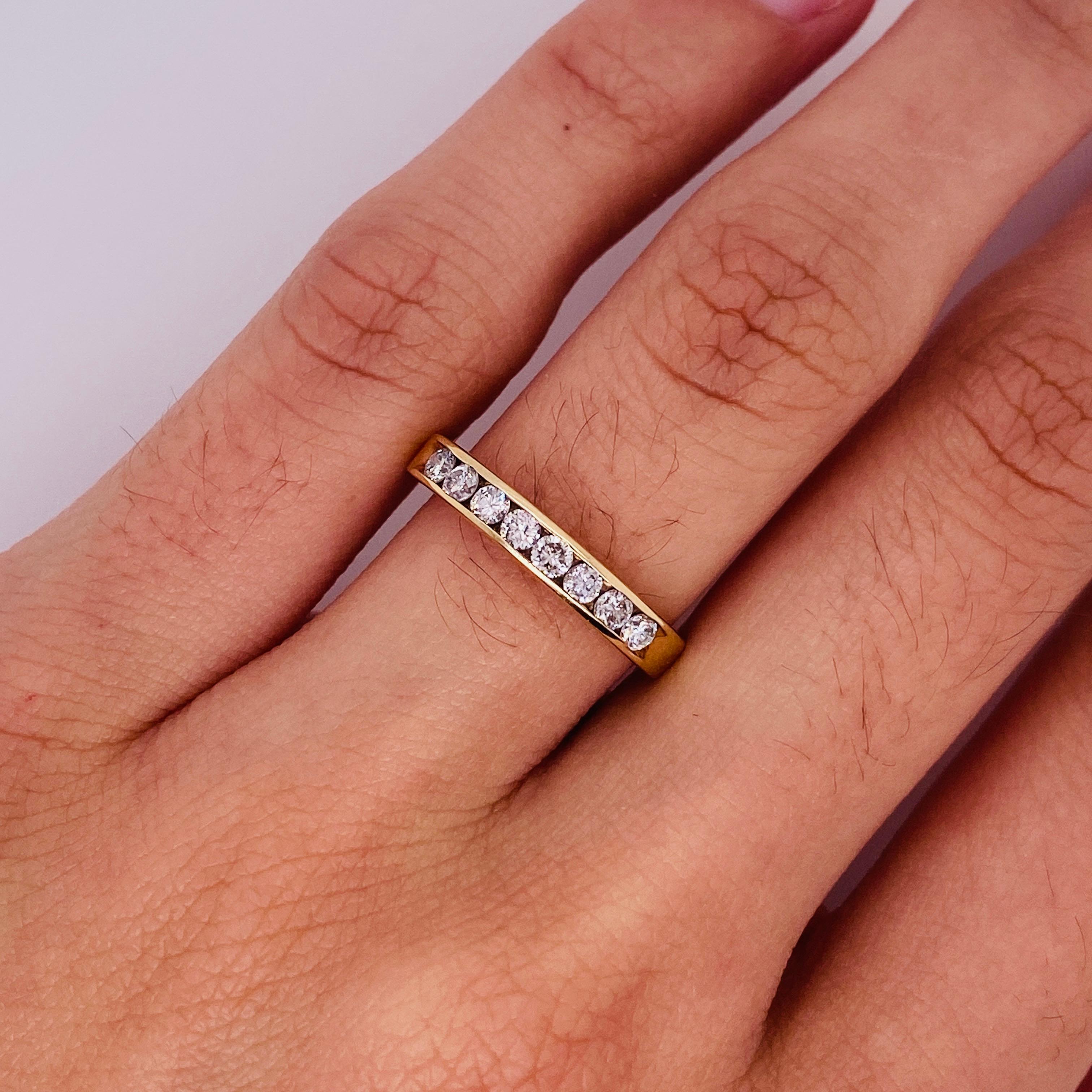 Sitting across the top of your finger, the channel of yellow gold creates a beautiful frame for the eight diamonds that seem to float next to each other. The sides of the ring are flat and smooth for easy stacking, and the band tapers down to a slim