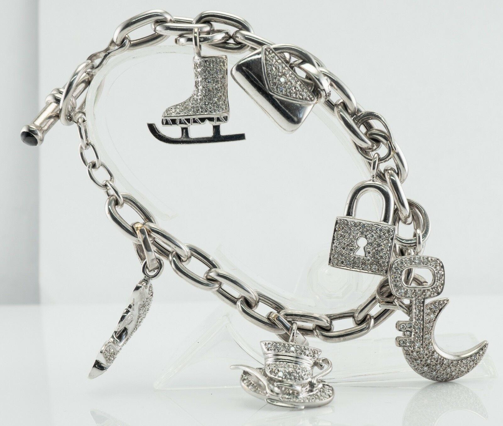 This amazing multi- charm diamond bracelet has been made in Italy. The chunky chain is made in solid 18K White Gold and all charms are solid 14K White Gold. There are seven charms depicting skates, crescent moon, dolphin (has a genuine Earth mined