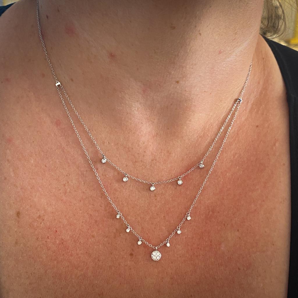 This gorgeous white gold two-strand diamond charm drop necklace is sure to put a smile on anyone's face! The double strand design is dynamic and unusual, giving the wearer movement and extra sparkle. You get two necklaces in one with this elegant