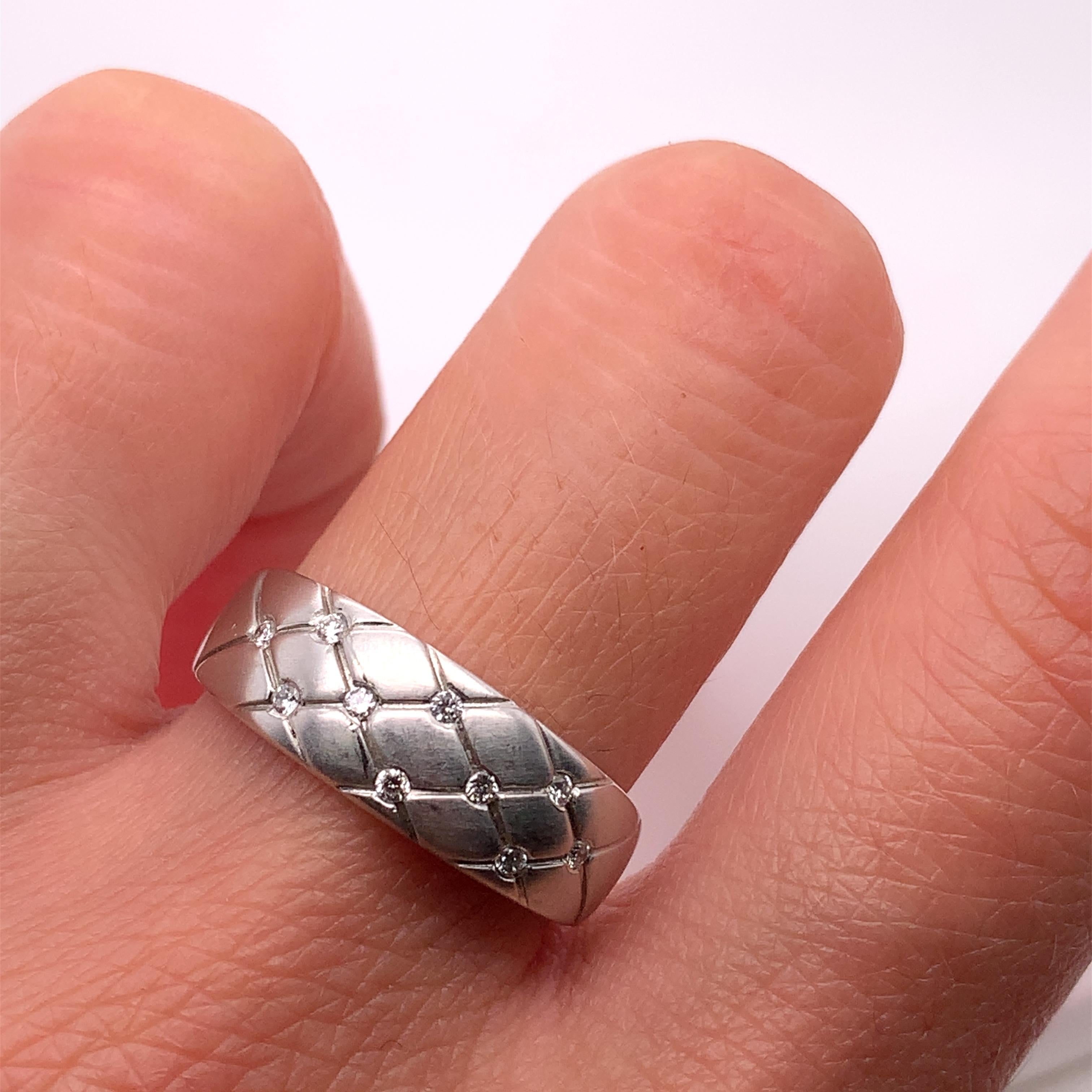 This stunning engagement band features a total of 10 natural round-cut diamonds with a combined carat weight of 0.20ct. The diamonds are set in a flush style on a 18ct white gold band with a matte finish. The ring is a size M 1/2 and has a band