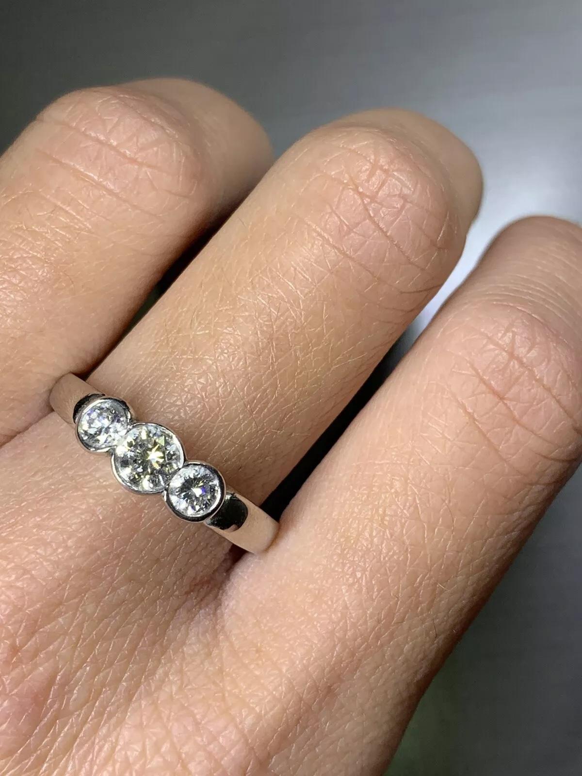 0.70ct round diamond trilogy engagement ring in platinum.

Classic three stone diamond ring trilogy style, bezel rubover setting diamonds.

Trilogy ring total diamond weight 0.70ct G colour VS1 clarity

The ring can be resized

Hallmarked

Box and
