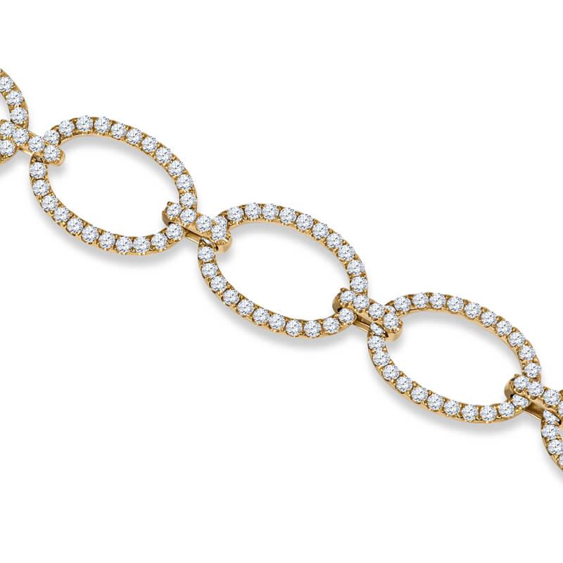 Lady's handmade bracelet in 18kt yellow gold featuring open sky oval links pave set with round full cut brilliant diamonds connected by diamond clustered looped links and featuring a diamond set double secured clasp for a total weight of  5.23