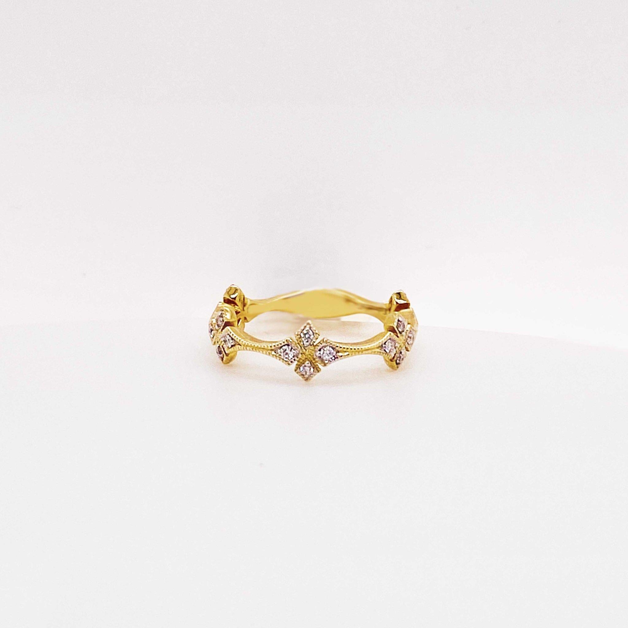 This fun, fashion diamond clover band is a bold and stunning design! The 14 karat yellow gold diamond band has a clover design with diamond clovers going 3/4 around the band. The clover has four petals, each set with a round brilliant diamond on
