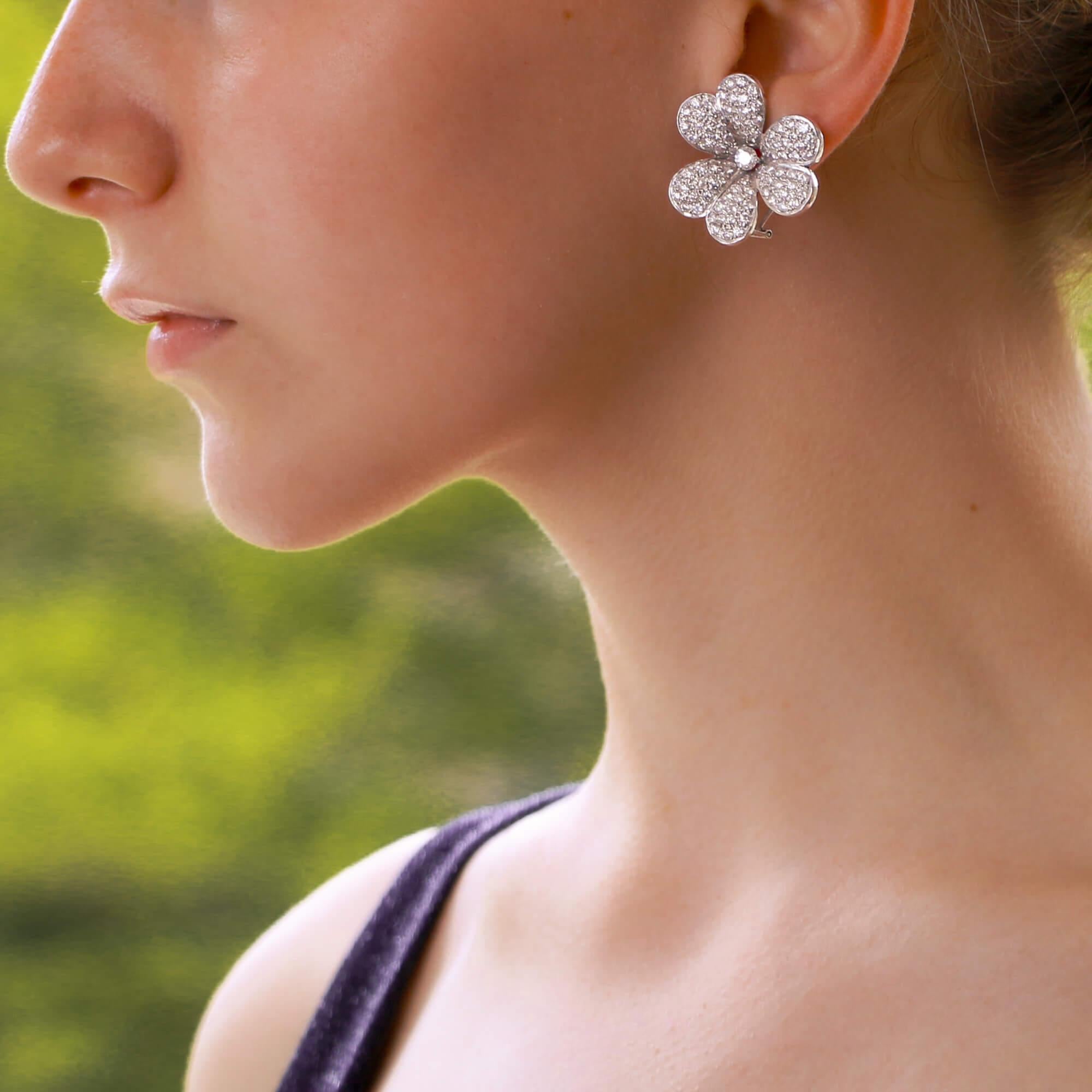 A beautiful pair of diamond clover flower earrings set in 18k white gold. 

Each earring is designed as a three-leaf clover flower pave-set throughout with incredibly white and sparkly round brilliant-cut diamonds. The clovers are centrally set with