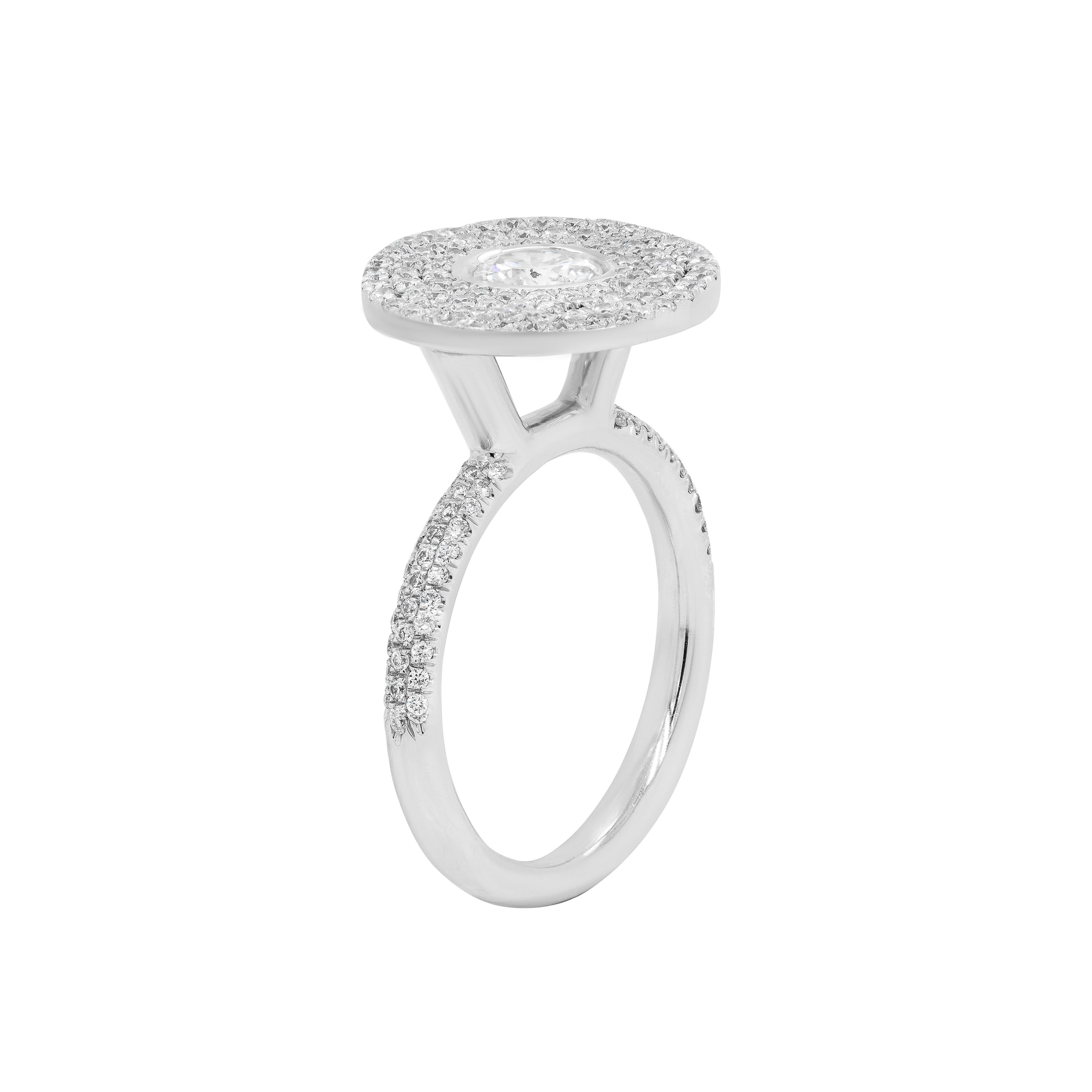 This gorgeous cocktail ring features a round brilliant cut diamond rub-over set in the centre, beautifully surrounded by three rows of smaller round brilliant cut diamonds, together completing the elegant cluster. The sparkling diamond cluster is