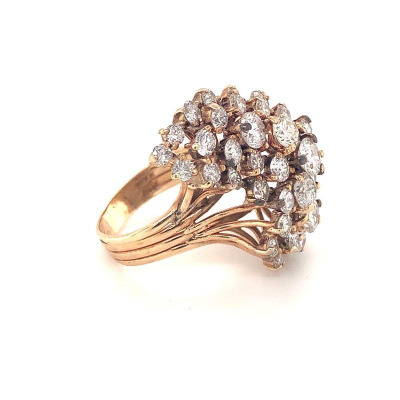 One diamond cluster 14K yellow gold ring featuring 47 round brilliant cut diamonds totaling 3.50 ct.  Measures 26 millimeters long, 14 millimeters wide at the center portion and 11 millimeters high when worn on finger.  Circa 1960s.

Impressive,