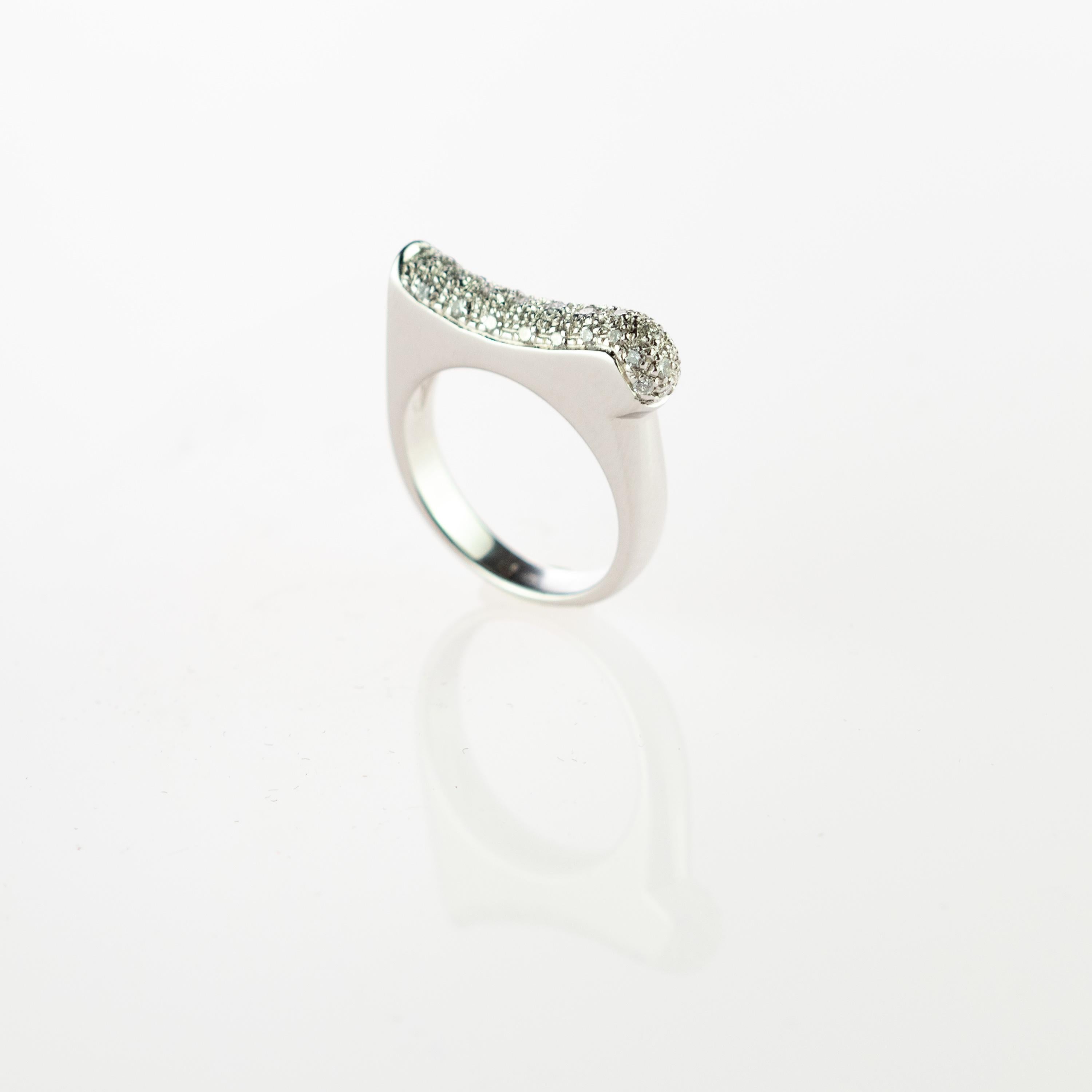 Brilliant cluster cut diamond ring with 0.33 carats embellished by 18 karat white gold. Unique and rare ring inspired in the belle epoque melted in prominent curves of change, modernity and evolution.
 
 A cocktail ring inspired by today's woman;