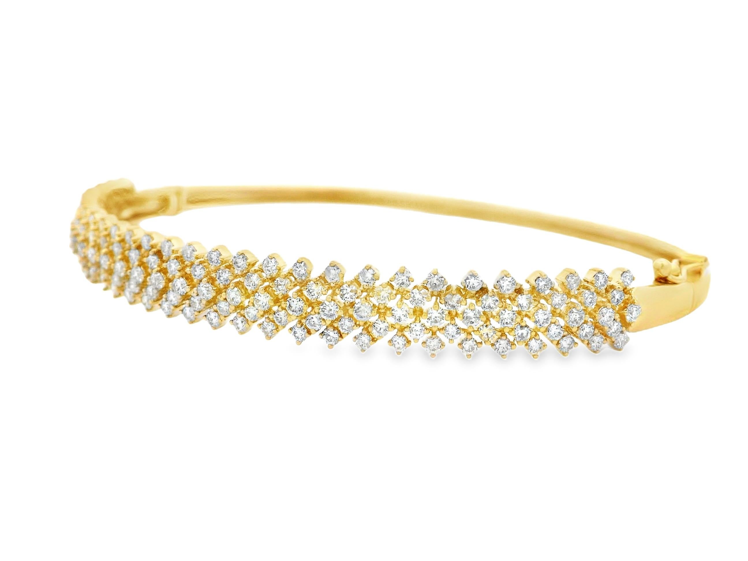 This radiant diamond bangle bracelet features 143 round brilliant-cut diamonds totaling approximately 1.66 carats, pavé-set in gleaming 14K yellow gold. The diamonds are arranged in a layered cluster pattern, forming a continuous wave of sparkle