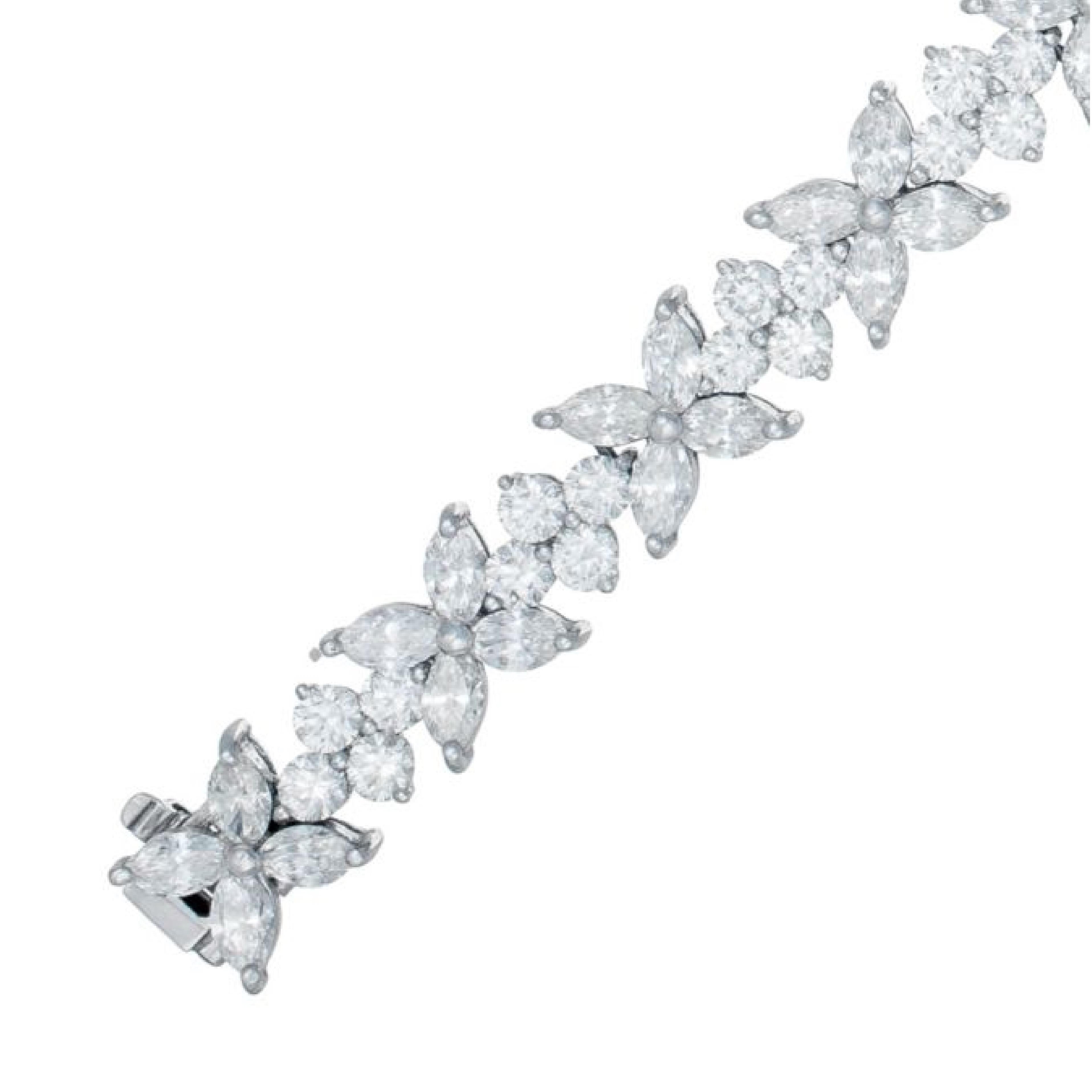 Diamond cluster bracelet
18K white gold bracelet with 16.50 carats of round and marquise cut diamonds in flower clusters 

Length: 7.5