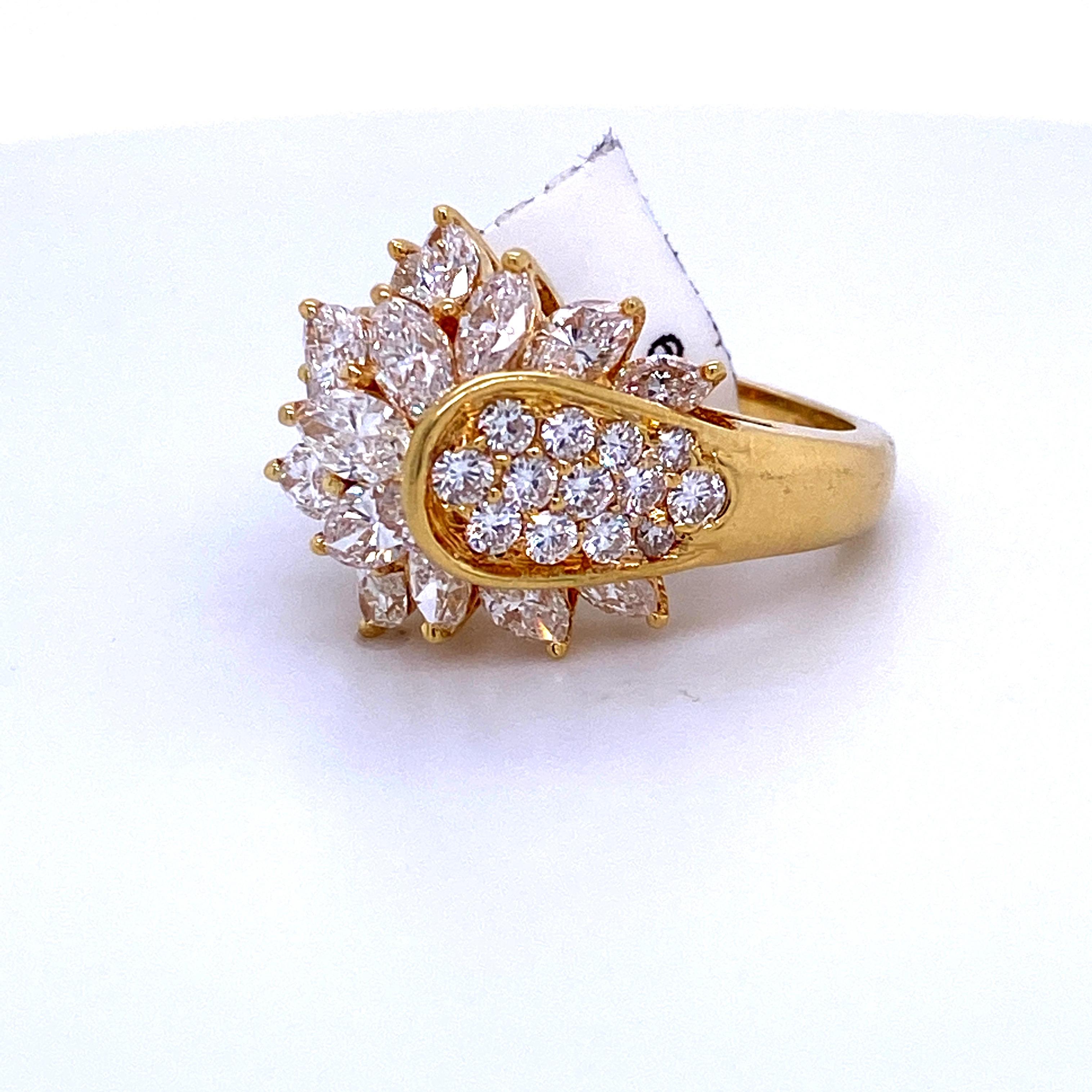 18K Yellow gold cluster ring featuring 18 round brilliants weighing 0.65 carats and 16 marquise diamonds weighing 2.49 carats. 
Color G
Clarity SI

Size 6.75
Sizeable free of charge.