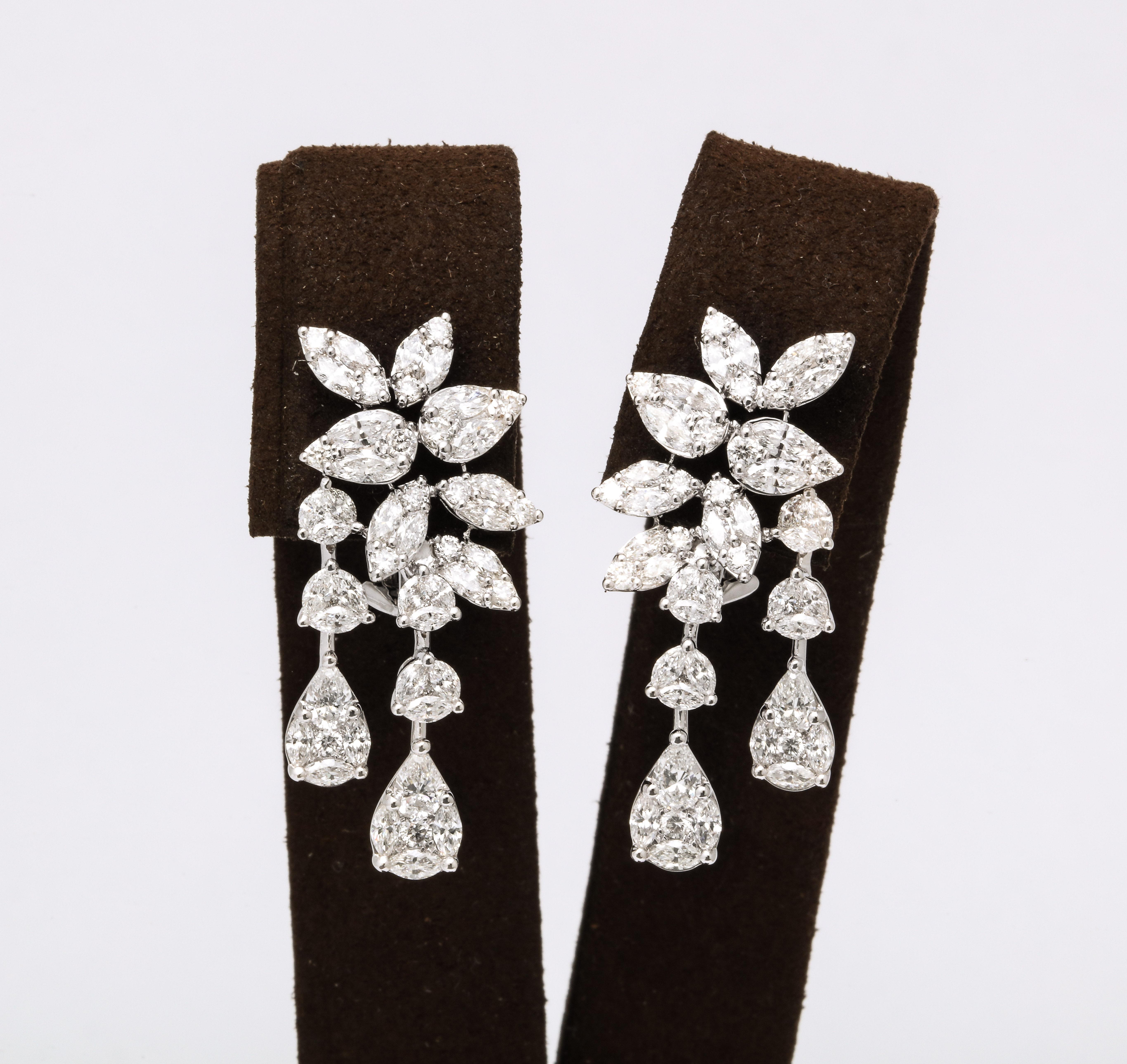 
A fabulous pair of illusion set diamond earrings. 

4.14 carats of multi-shape diamonds set in 18k white gold. 

1.25 inches from the highest to lowest points, over half an inch wide. 

An impeccable design! 