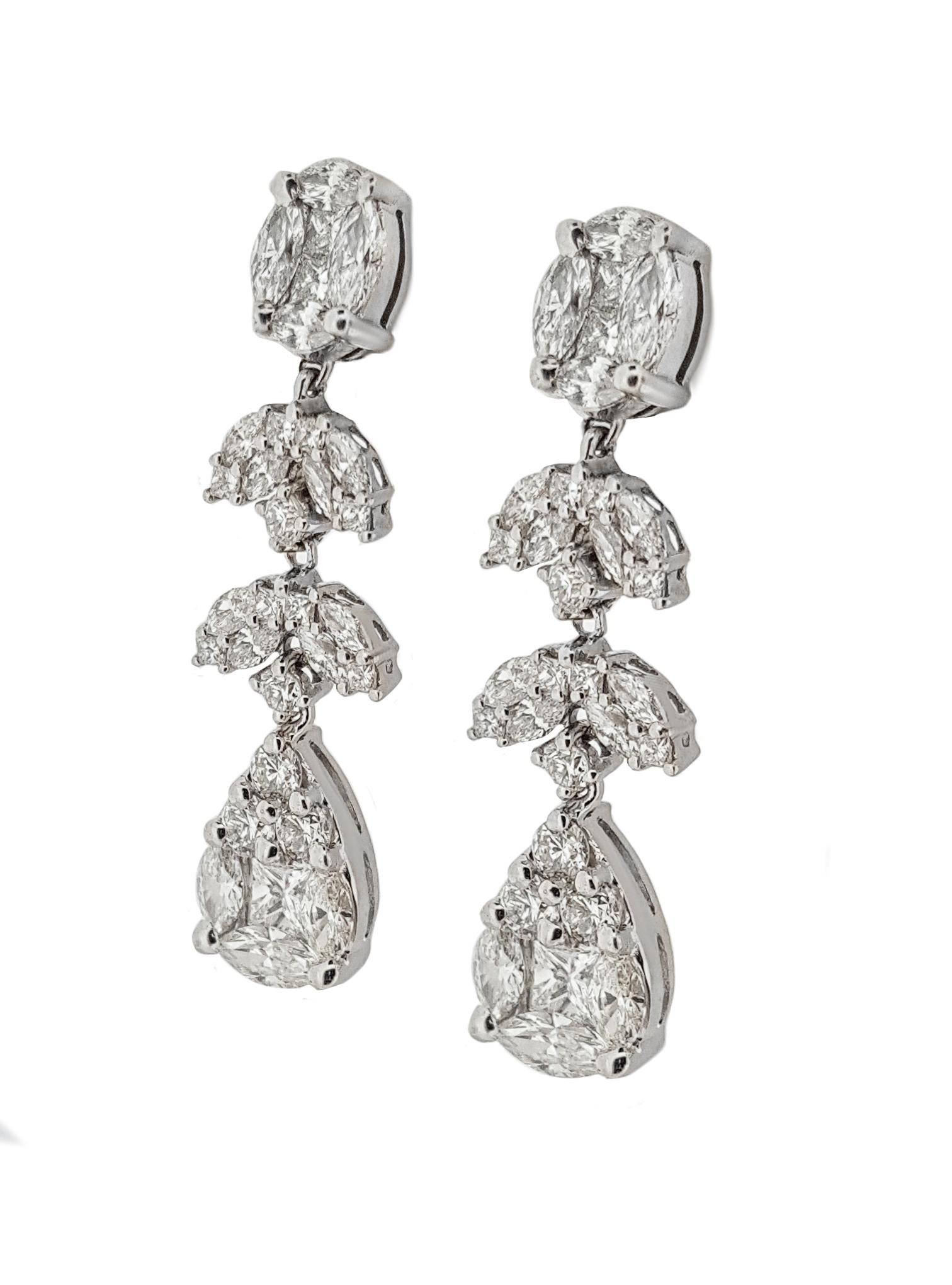 You are sure to sparkle with these incredible diamond cluster dangle earrings. Set in high polished 14kt white gold and containing 3.28ctw of full cut brilliant diamonds G-I in color and VS in clarity. Earrings measure approximately 1.25 inches long
