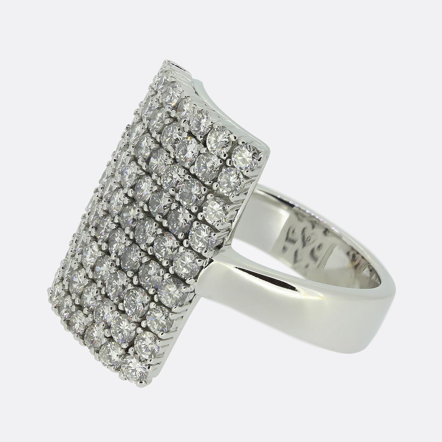 Here we have a large diamond cluster dress ring. This 18ct white gold piece plays host to 63 round brilliant cut diamonds; all of which have been individually claw set in a collective rectangular shape.

Condition: Used (Very Good)
Weight: 13.4