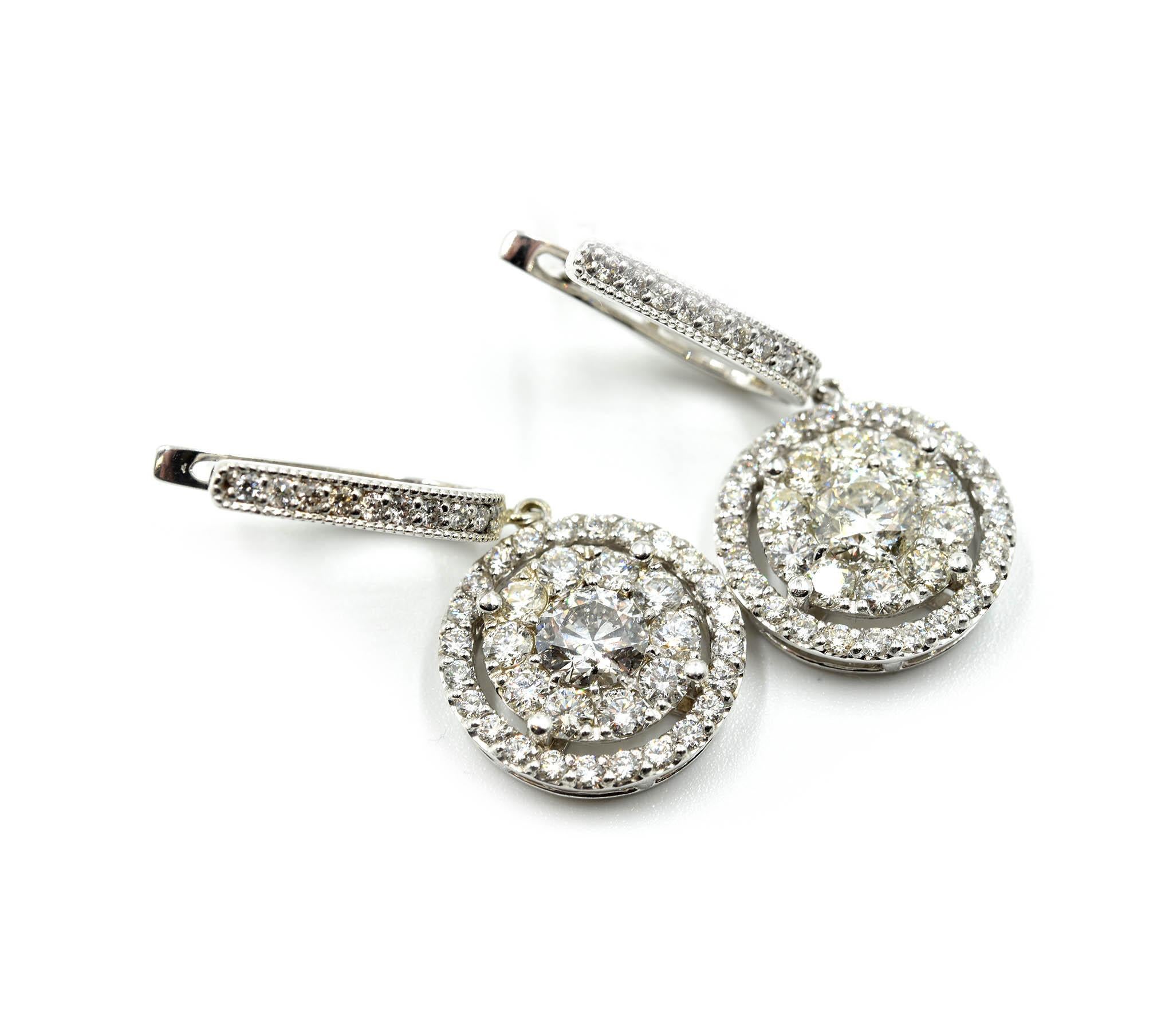 Designer: custom design
Material: 14k white gold
Diamonds: 92 round brilliants = 4.44 carat total weight
Dimensions: each earring dangles 1 ½ an inch and the cluster measures 3/4th an inch in diameter
Fastenings: snap closures
Weight: 9.50 grams
