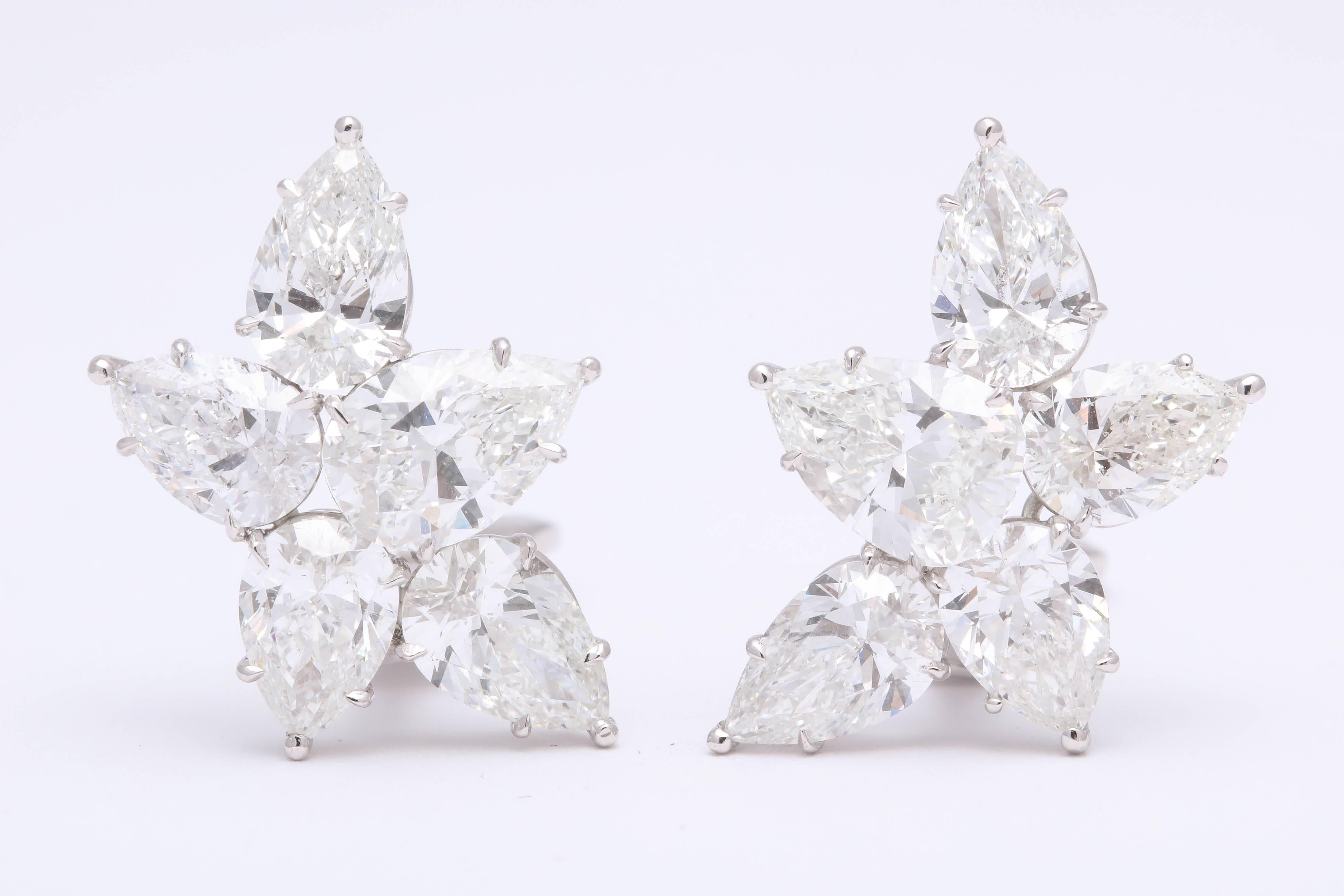 
An incredible pair of diamond cluster earrings.  

8.17 carats of white F/G color VS clarity pear shapes set in a handmade platinum mounting. The two largest diamonds weigh over 1 carat each and are GIA certified. 

An impeccably designed