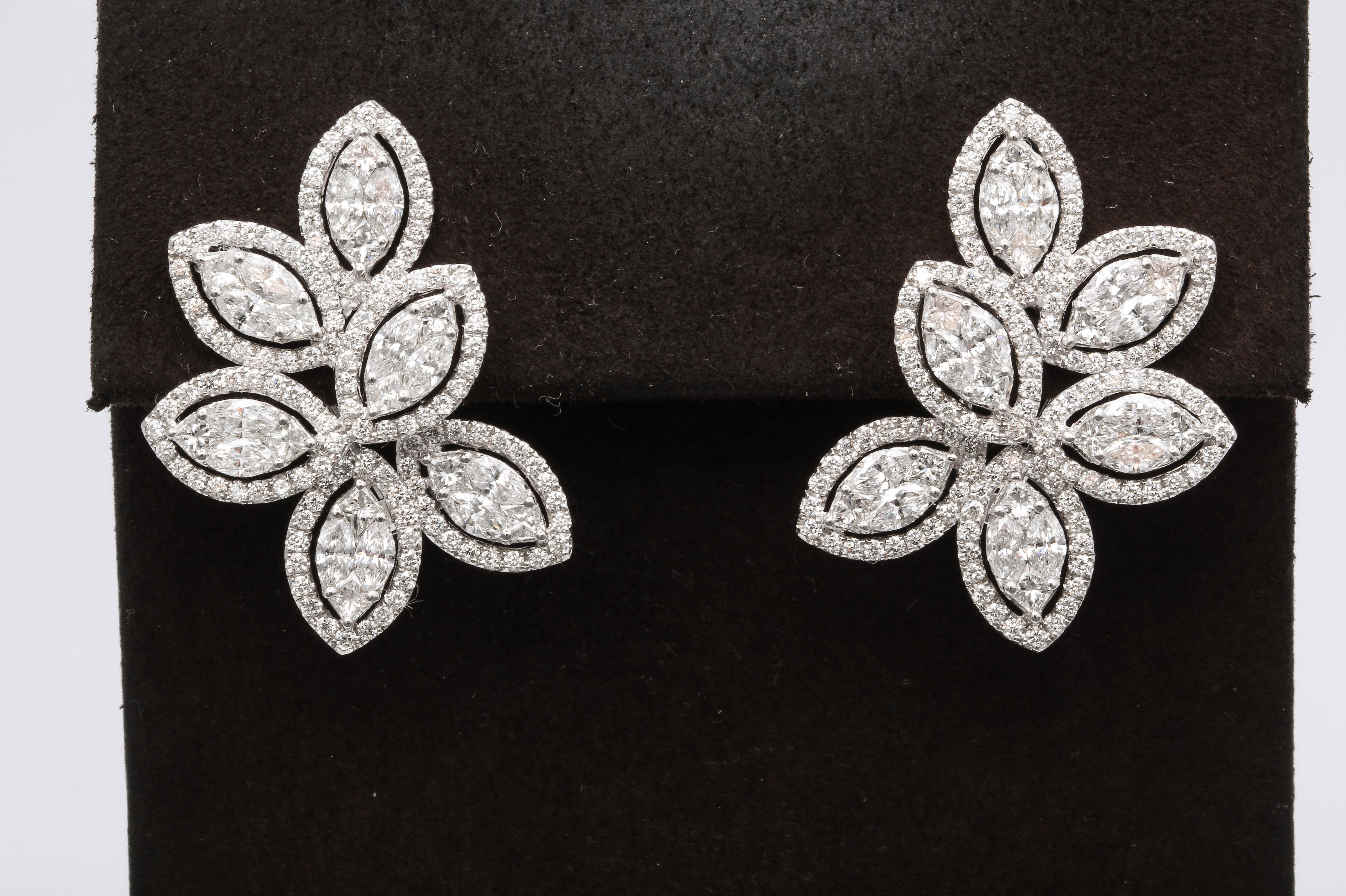 
A stunning pair of Diamond Cluster Halo Earrings 

6 Illusion set marquise diamonds surrounded by thin round brilliant cut halos for maximum sparkle!

6.06 carats set in 18k white gold.

Approximately 3 cm long and 2.2 cm wide. 
