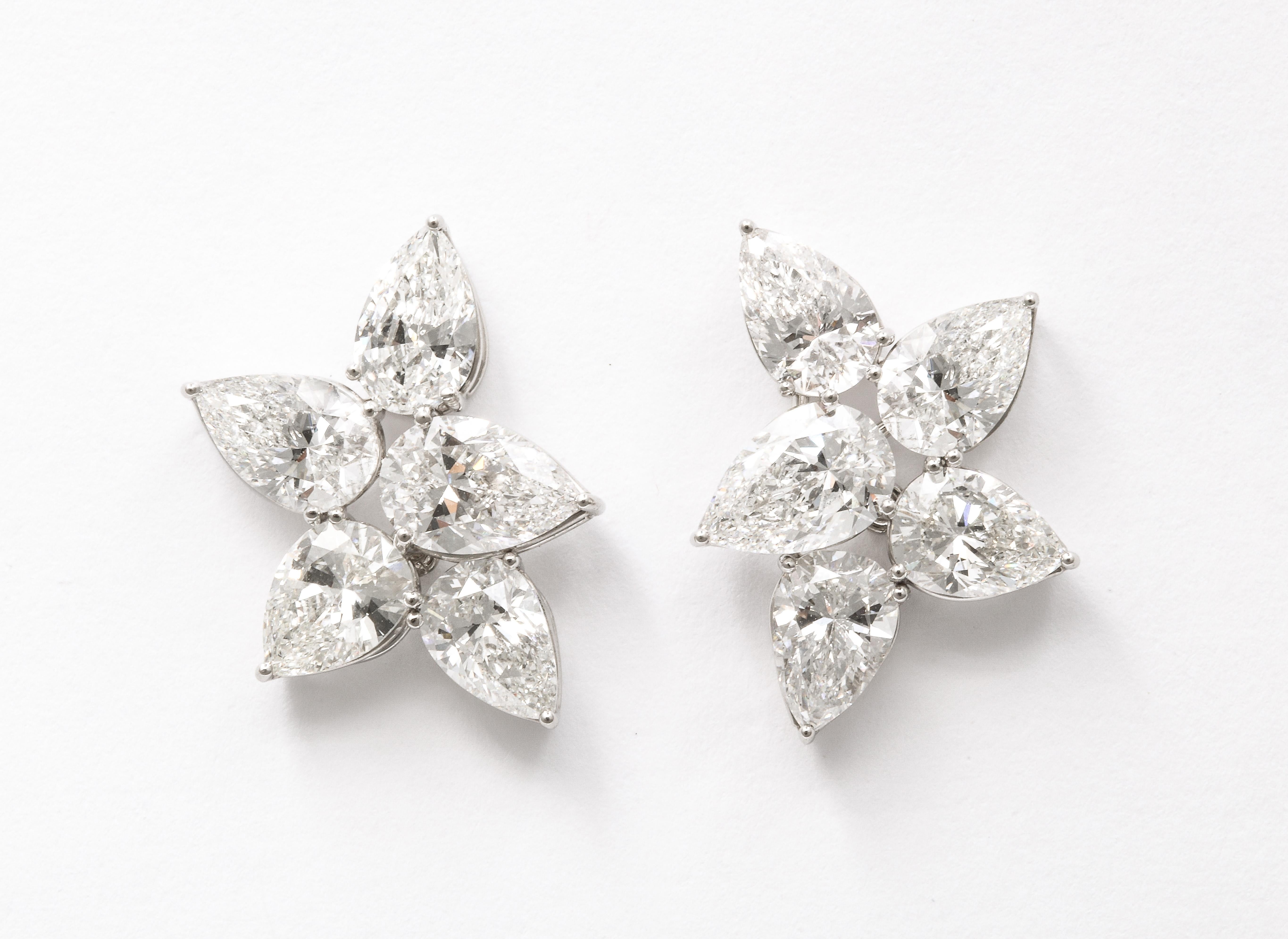 
8.29 carats of colorless white pear shapes set in a handmade platinum mounting. 

Approximately .75 inches long and .60 inches wide. 

An INCREDIBLE pair of cluster earrings only found in the worlds top jewelry houses. 