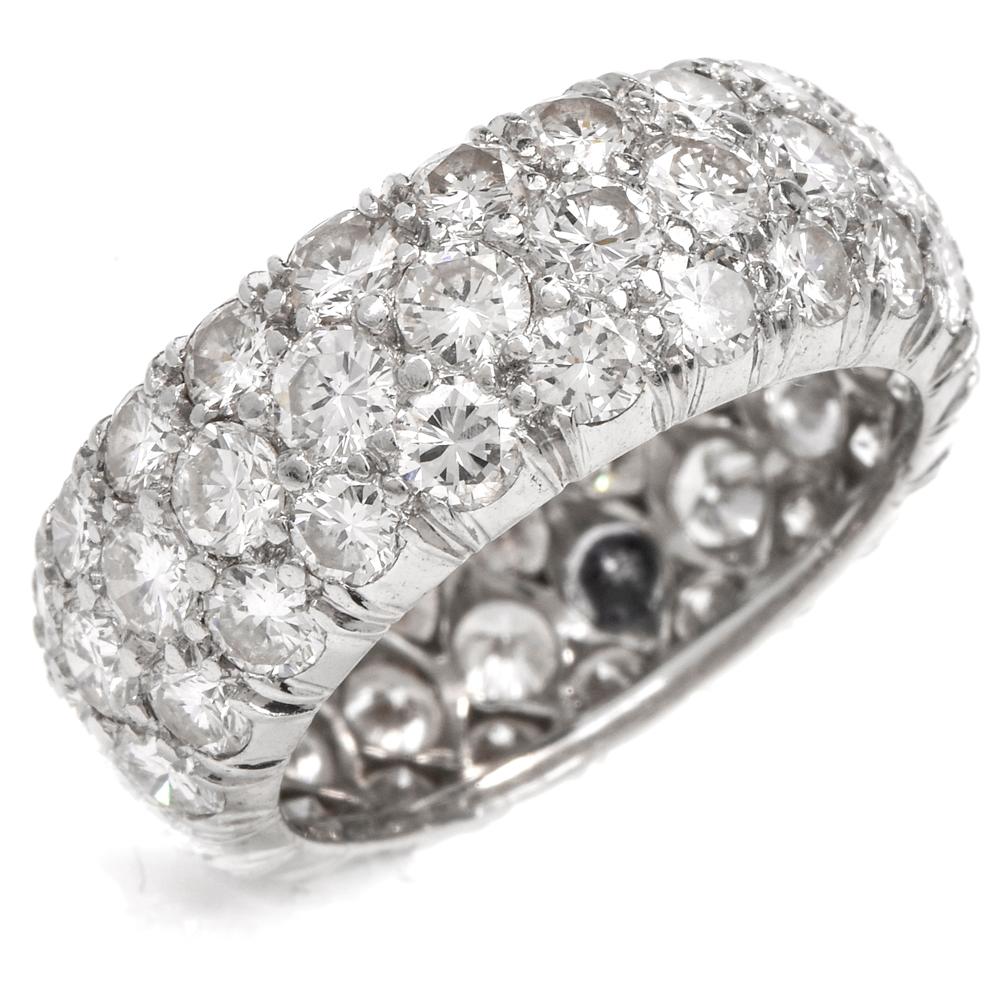 This estate diamond custer eternity ring is crafted in solid platinum. Adorned with approximately 63 prong-set round-cut diamonds approx. 5.65 carats, graded H-I color, VS1-VS2 clarity. Weighing 5.8 grams and measuring 7mm high. current Ring Size is