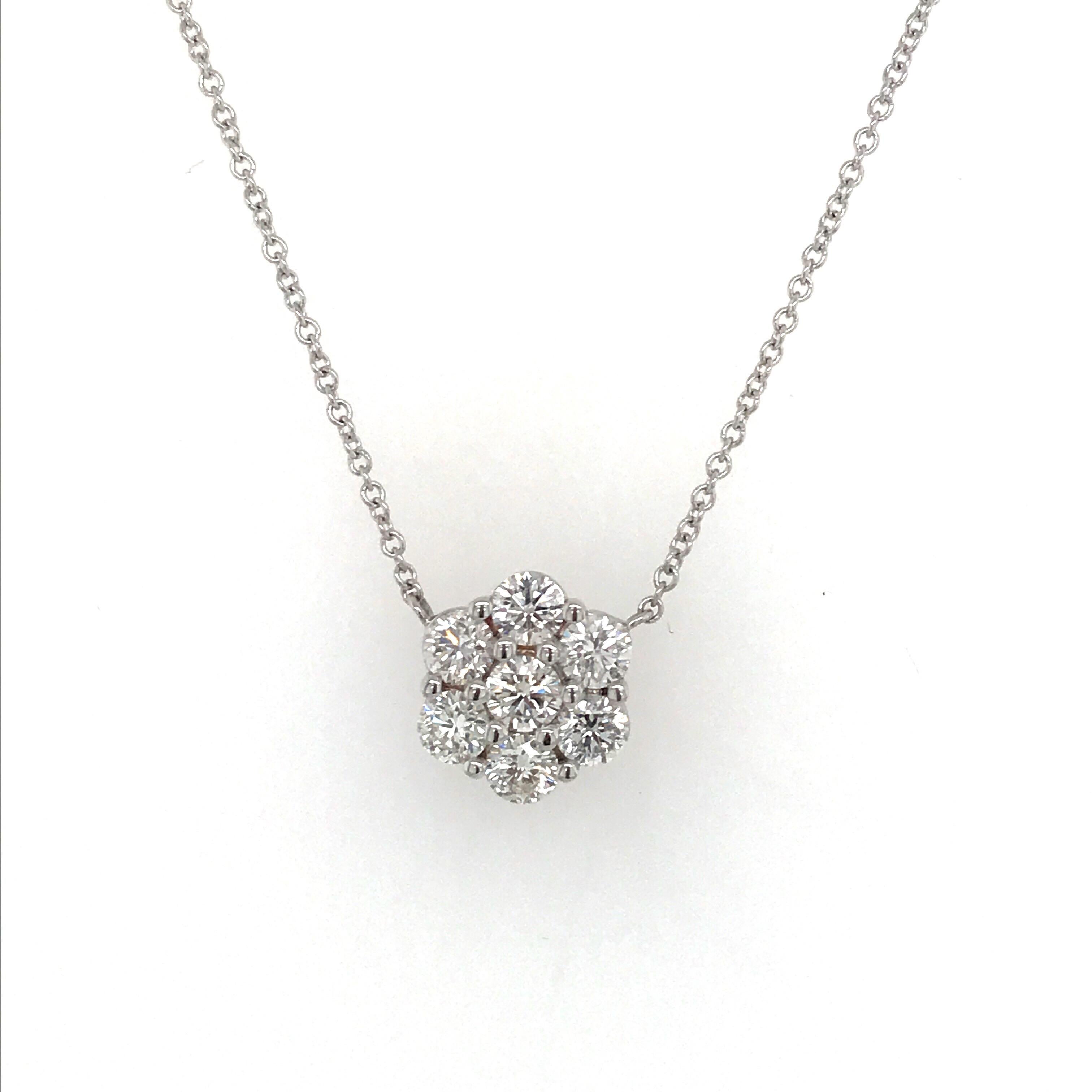 18K White Gold diamond cluster pendant featuring 7 round brilliants weighing 0.79 carats extended on a 16 inch chain. 
A timeless piece of jewelry. 
Also available in earrings. 
Color: H
Clarity SI1