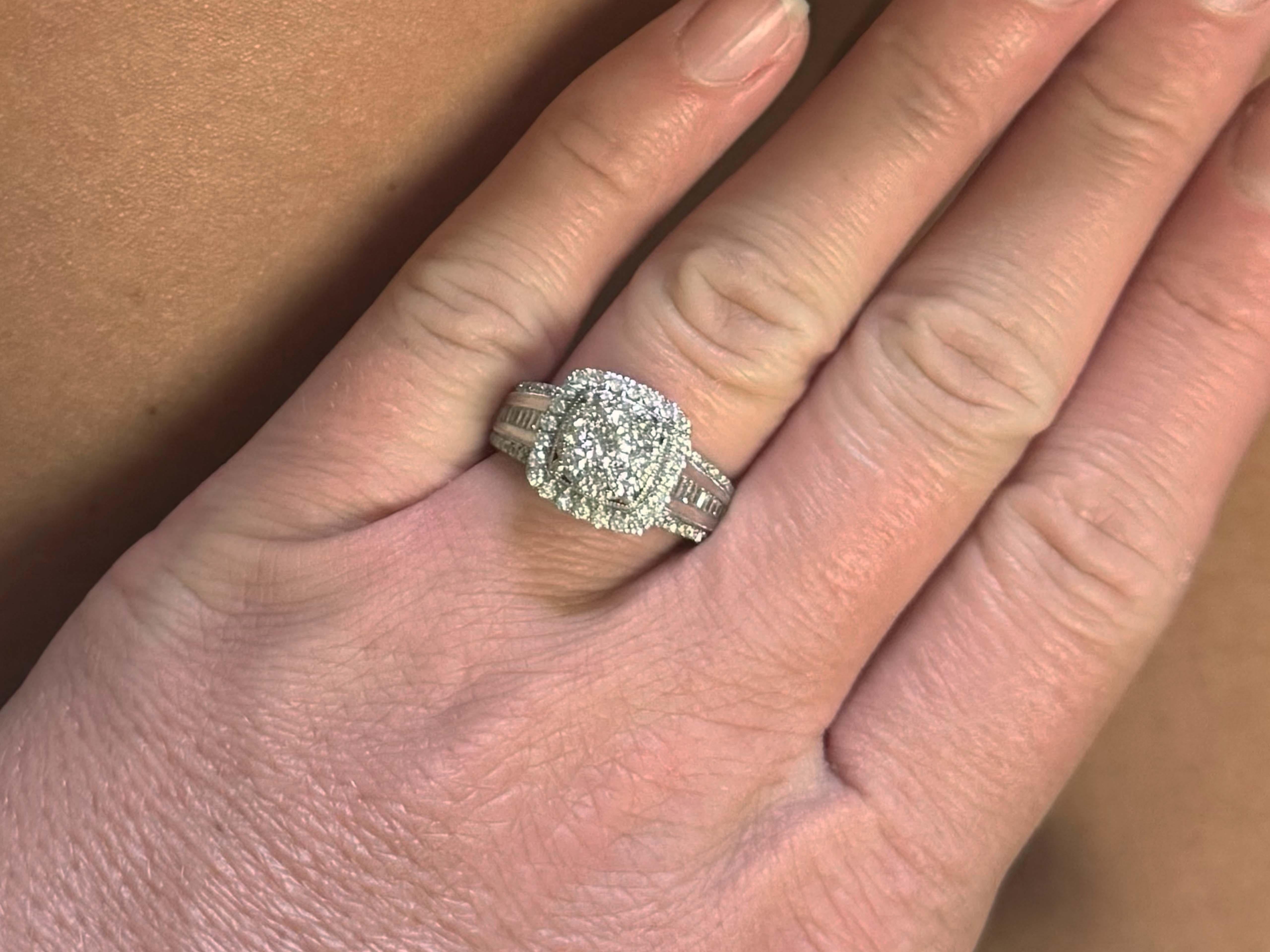 Item Specifications:

Metal: 10k White Gold 
​
​Center Diamond Info: 0.15 carats, G color, I1 clarity

​8 Diamond Halo Info: 0.24 carats, G color, I1 clarity

24 Diamond Halo Info:  0.36 carats, G-I color, SI2-I1 clarity

​20 Baguette Diamonds Info: