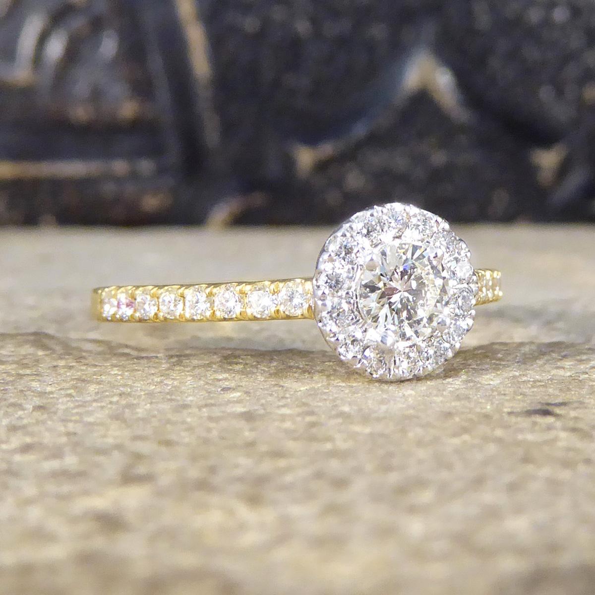 The perfect sparkly engagement ring. This ring features a Diamond in the centre weighing 0.22ct with a cluster of smaller Diamonds surrounding it set with the illusion of a larger Diamond, giving extra sparkle in an 18ct White Gold setting on the
