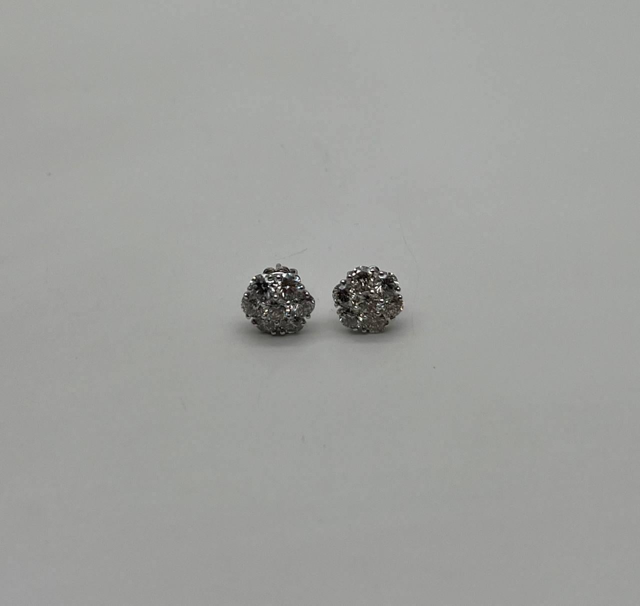 Discover the elegance of these diamond cluster earrings. Featuring a dazzling array of round diamonds, these earrings create a captivating sparkle. 14K White Gold. 0.35 CTW Diamonds.