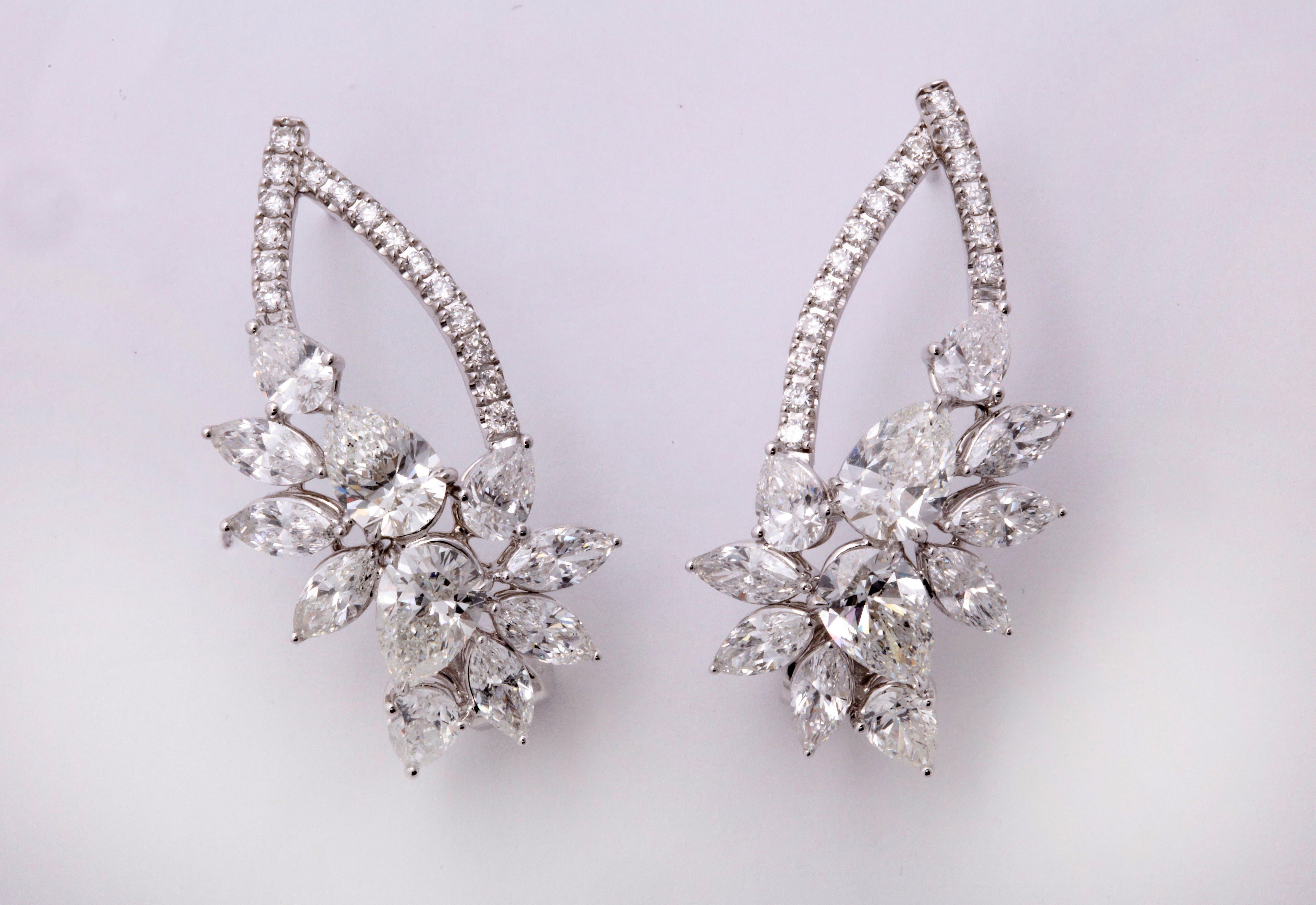 
A unique take on the classic cluster earring!

8.56 carats of white round, pear and marquise shaped diamonds set in 18k white gold.

The 