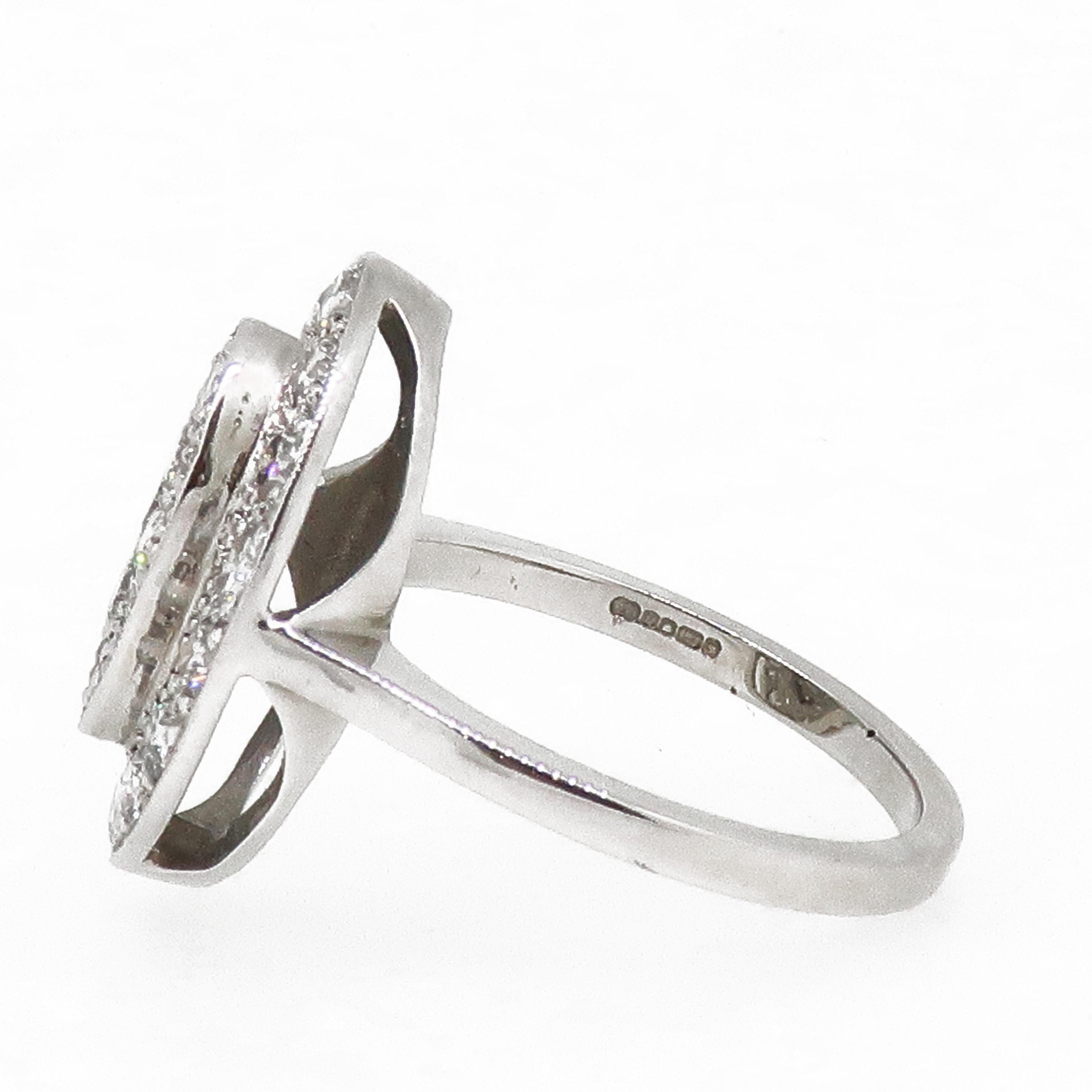 Diamond Cluster Ring 18 Karat White Gold

A dazzling diamond cluster ring. This plaque style diamond cluster is marquise in shape, with a raised marquise centre. The ring is set with sparkling brilliant cut diamonds all set in a grain setting on