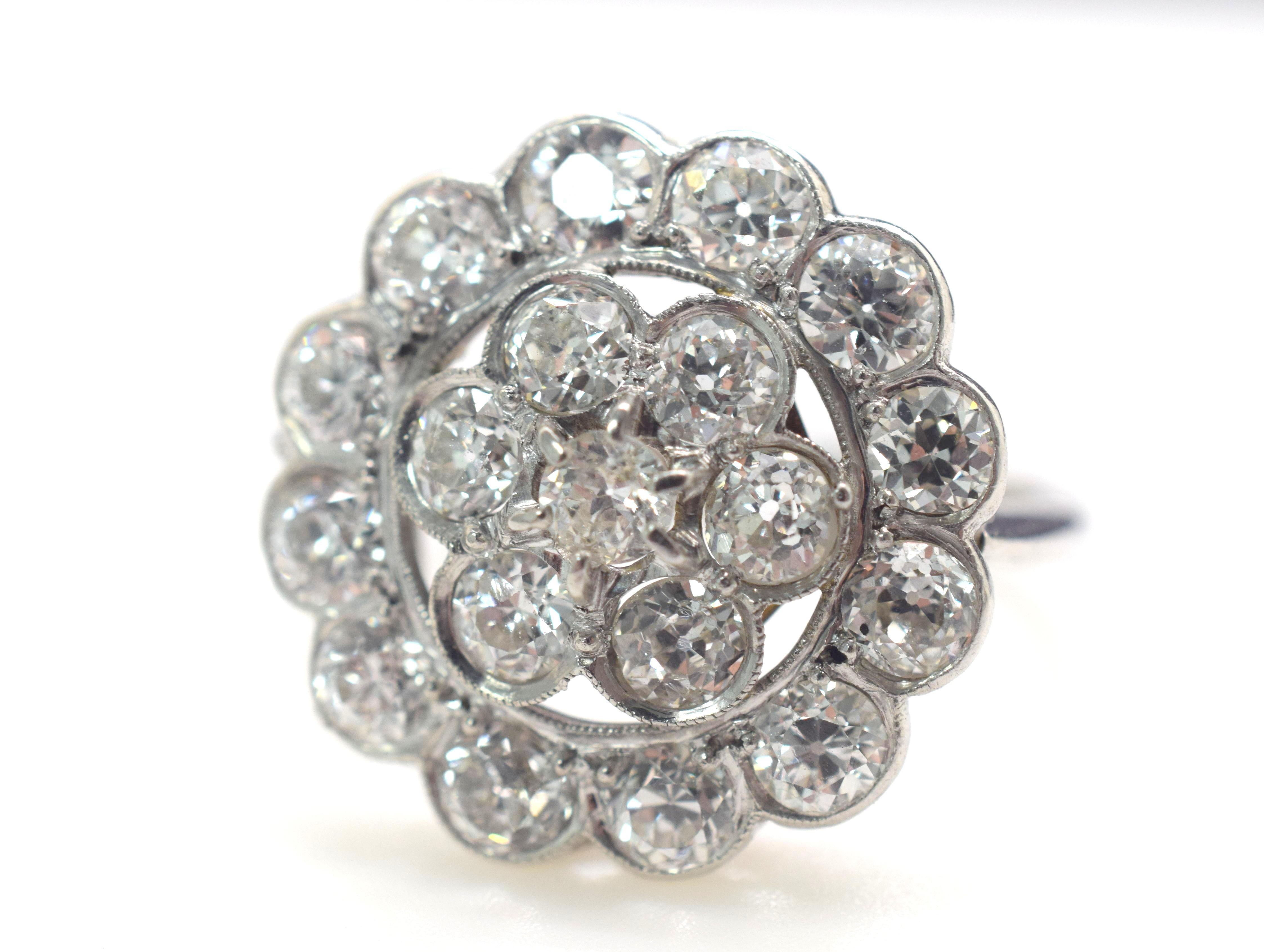 Gorgeous vintage ring for her. This Diamond Cluster ring is crafted in both platinum and 18k white gold. The head of the ring with the Diamonds is set in platinum and the shank is 18k. A total of 3.00 Tcw is set into this ring  with Diamonds