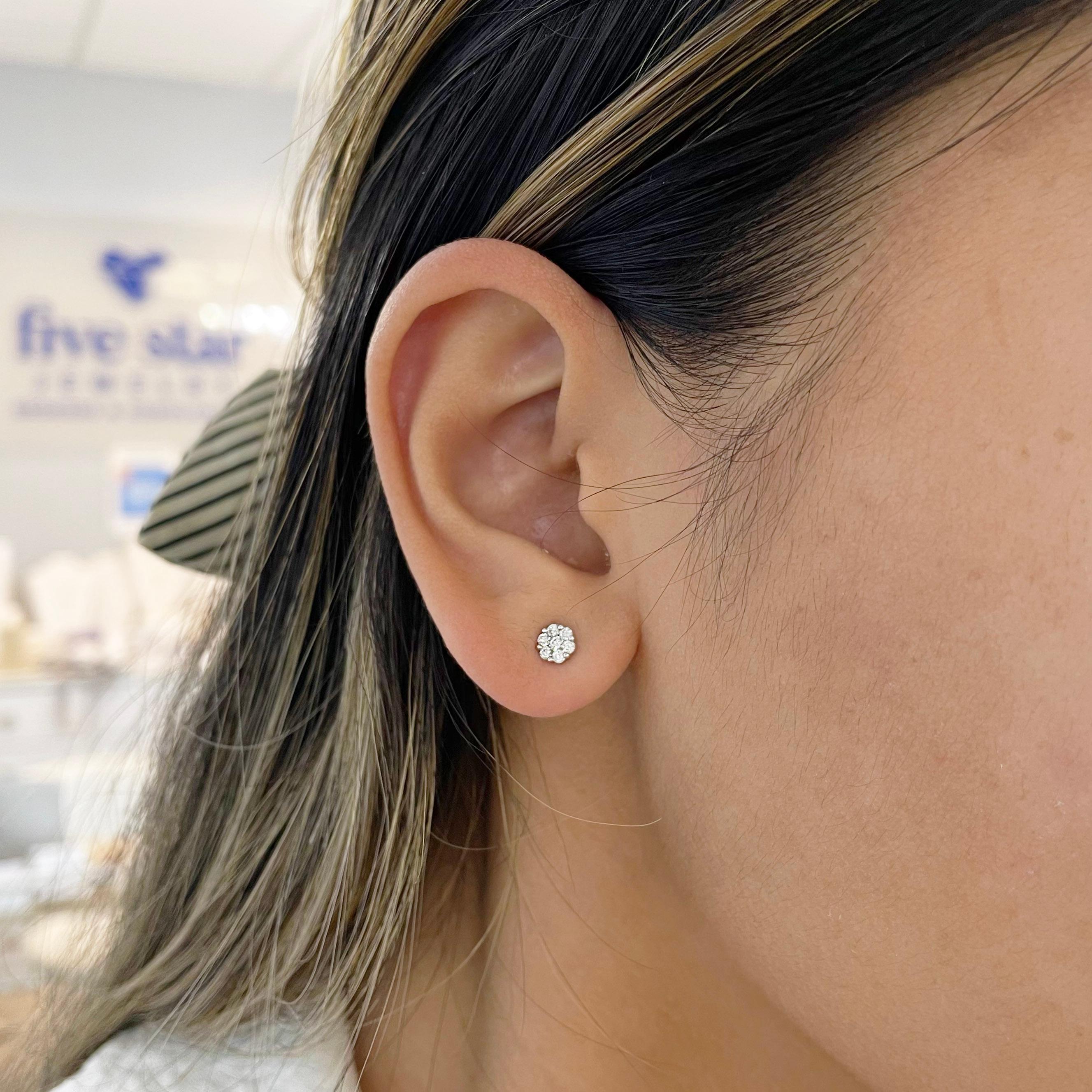 These dainty diamond studs mimics a floral design. Each stud is made up of 7 round brilliant diamonds in a white gold setting exaggerating the white of the diamonds. The details for these gorgeous earrings are listed below:
1 Set
Metal Quality: 14K