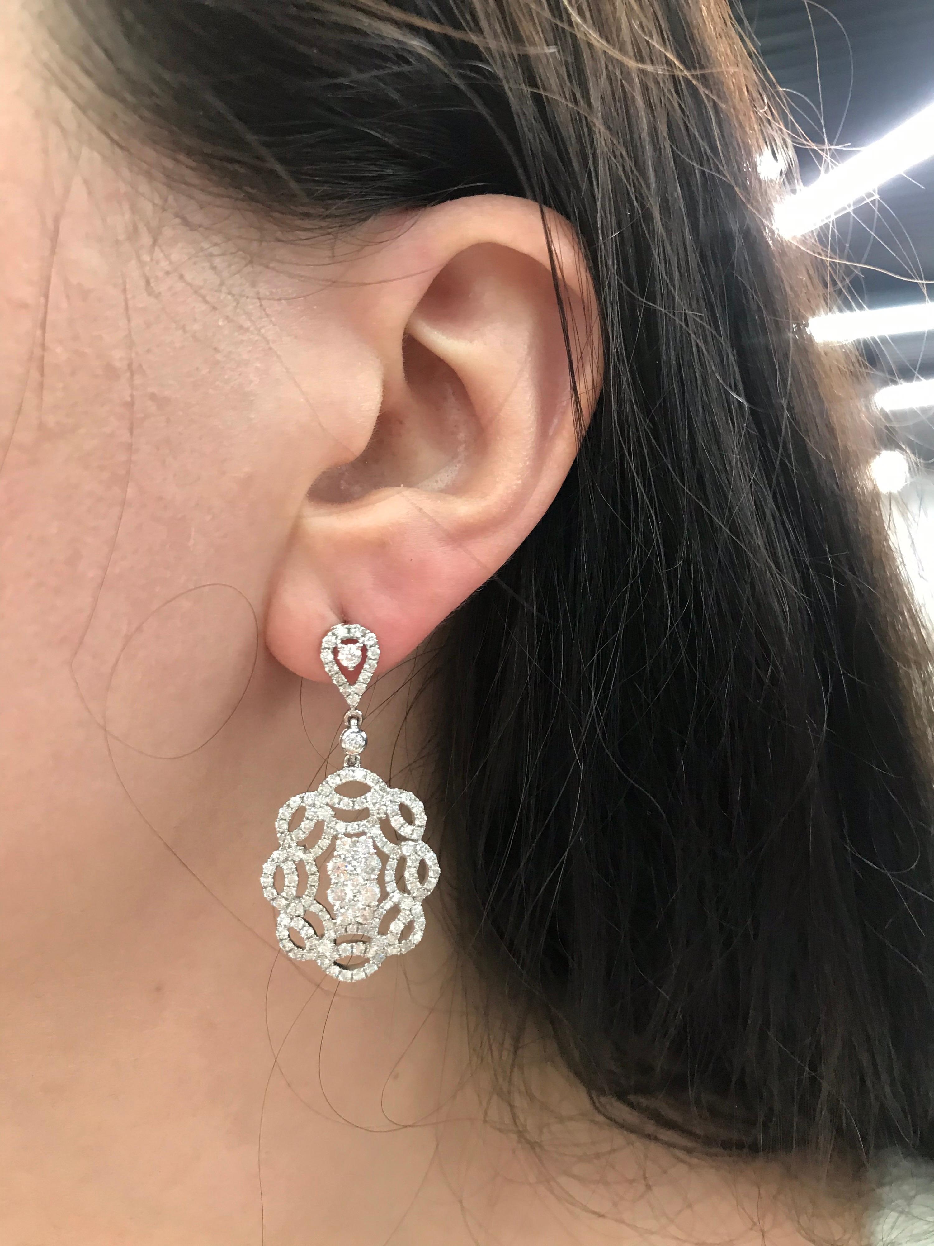 14K White gold drop swirl earring featuring numerous round brilliant diamonds weighing approximately 2 carats. 
Color H
Clarity SI2