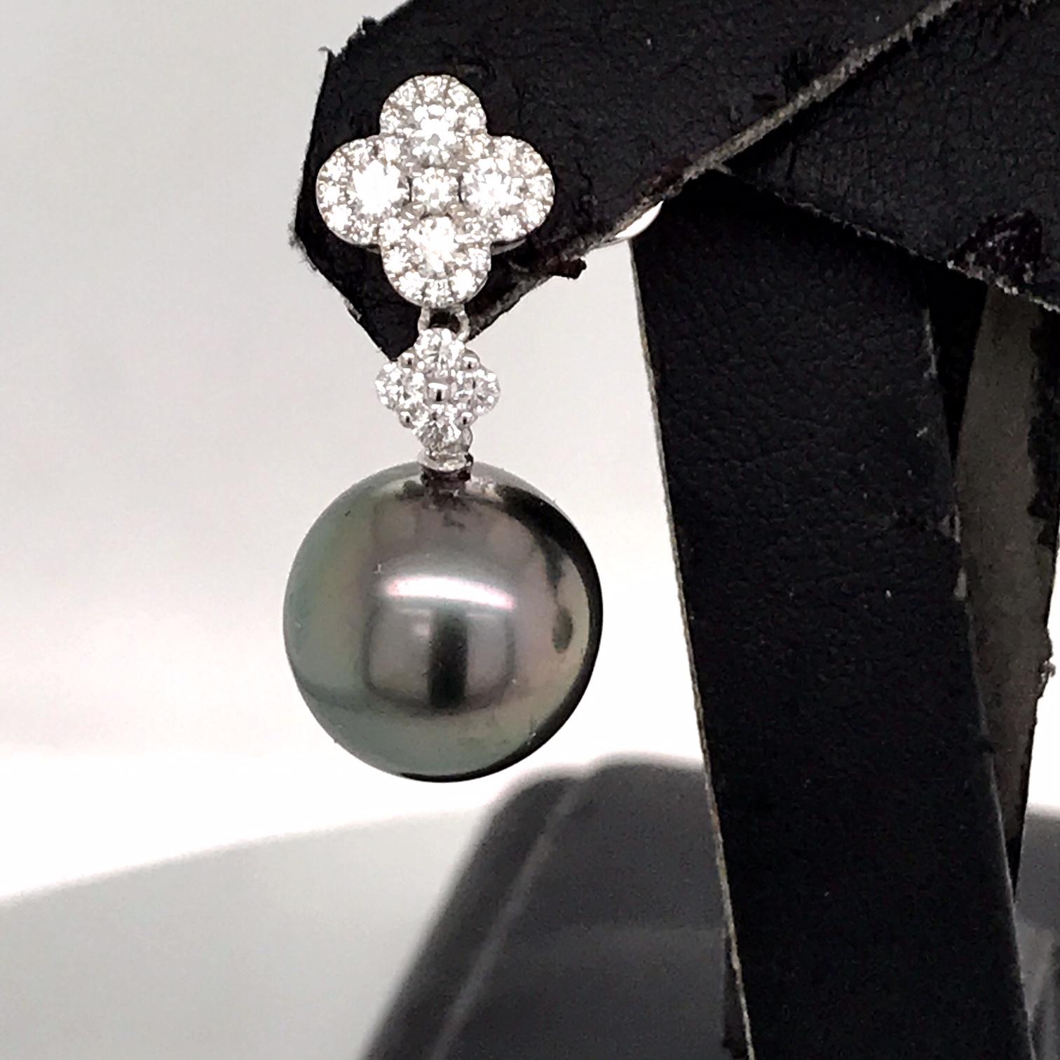 18K White gold drop earrings featuring two Tahitian Pearls measuring 11-12 mm with 8 round brilliants on top weighing 0.37 carats flanked with 58 smaller diamonds weighing 0.40 carats.
Color G-H
Clarity SI

Width of top cluster: 3/8