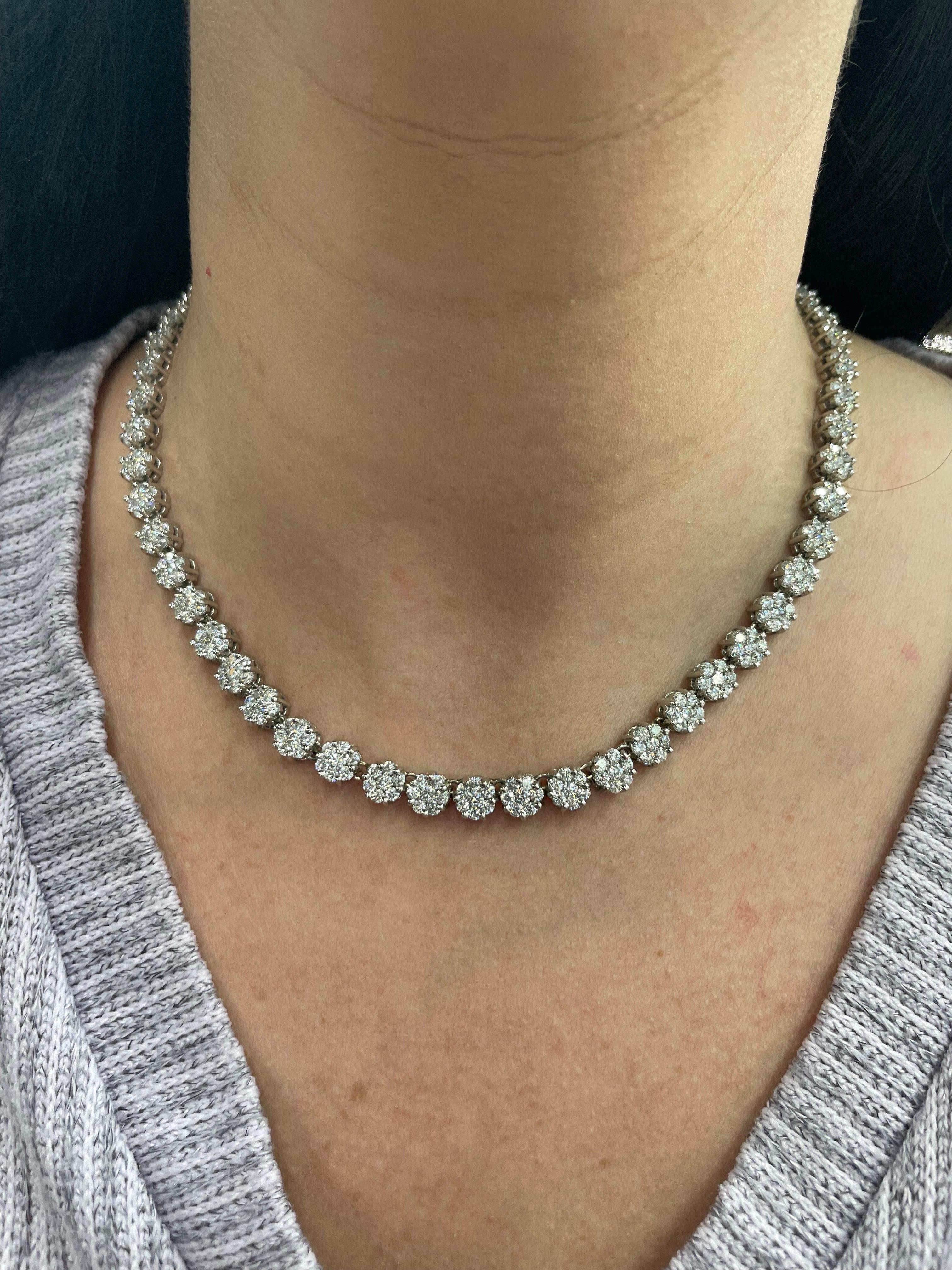 14 Karat White Gold tennis necklace featuring 52 clusters weighing approximately 20 carats.
Color H
Clarity SI
Big look on the neck! 