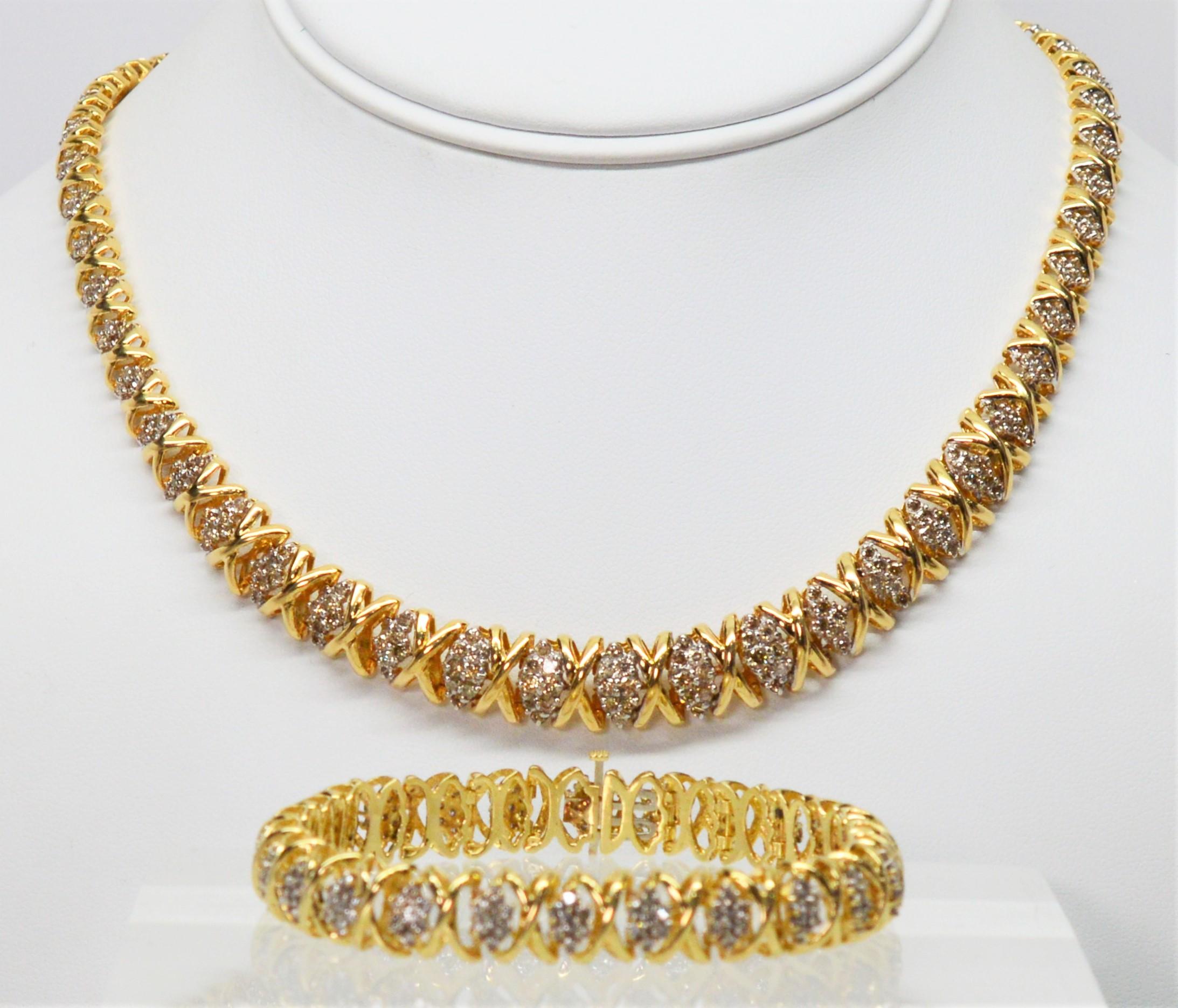 Stunning diamond clusters crossed with yellow gold make this timeless necklace and bracelet set an exquisite selection for that special occasion. Each separate link is crafted with four round diamond stones that are prong set in a marquise shape