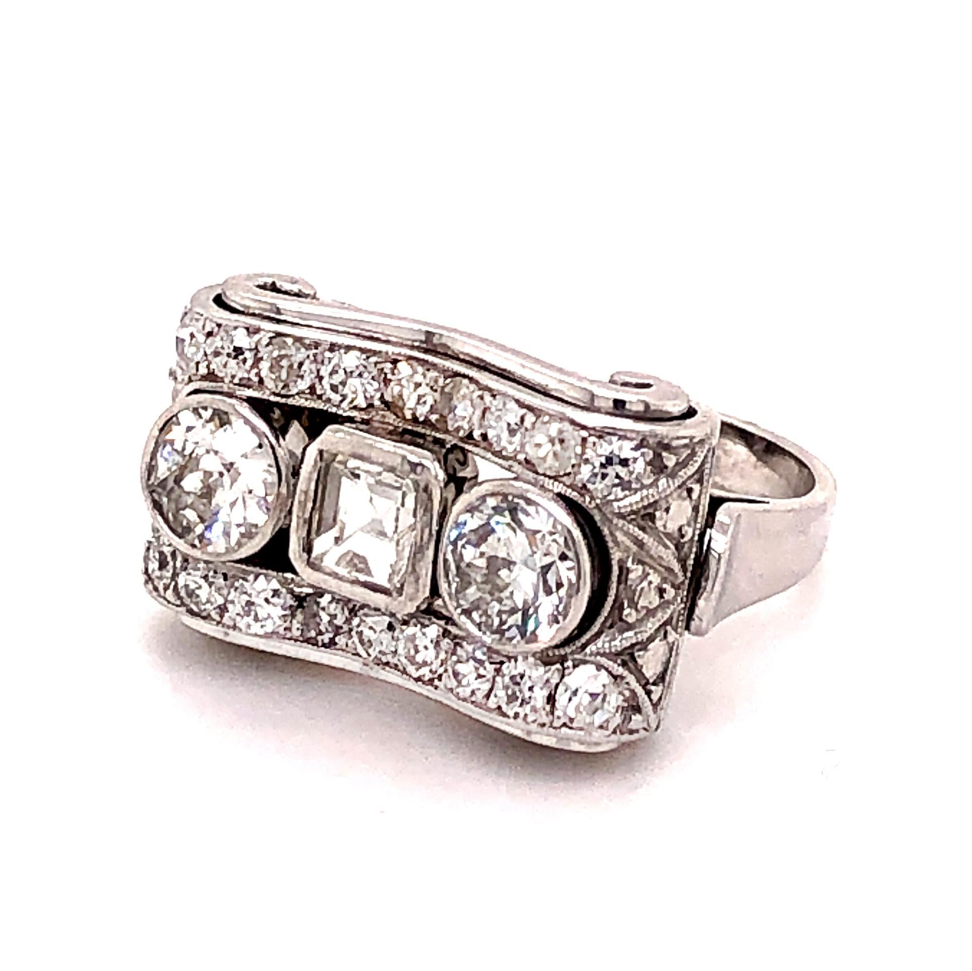 A lovely diamond ring from the 1950s, which can be worn everyday. It is centred with two round brilliant cut and one square cut diamond in the middle and accentuated with smaller round brilliant cut diamonds at the top and bottom - the total diamond