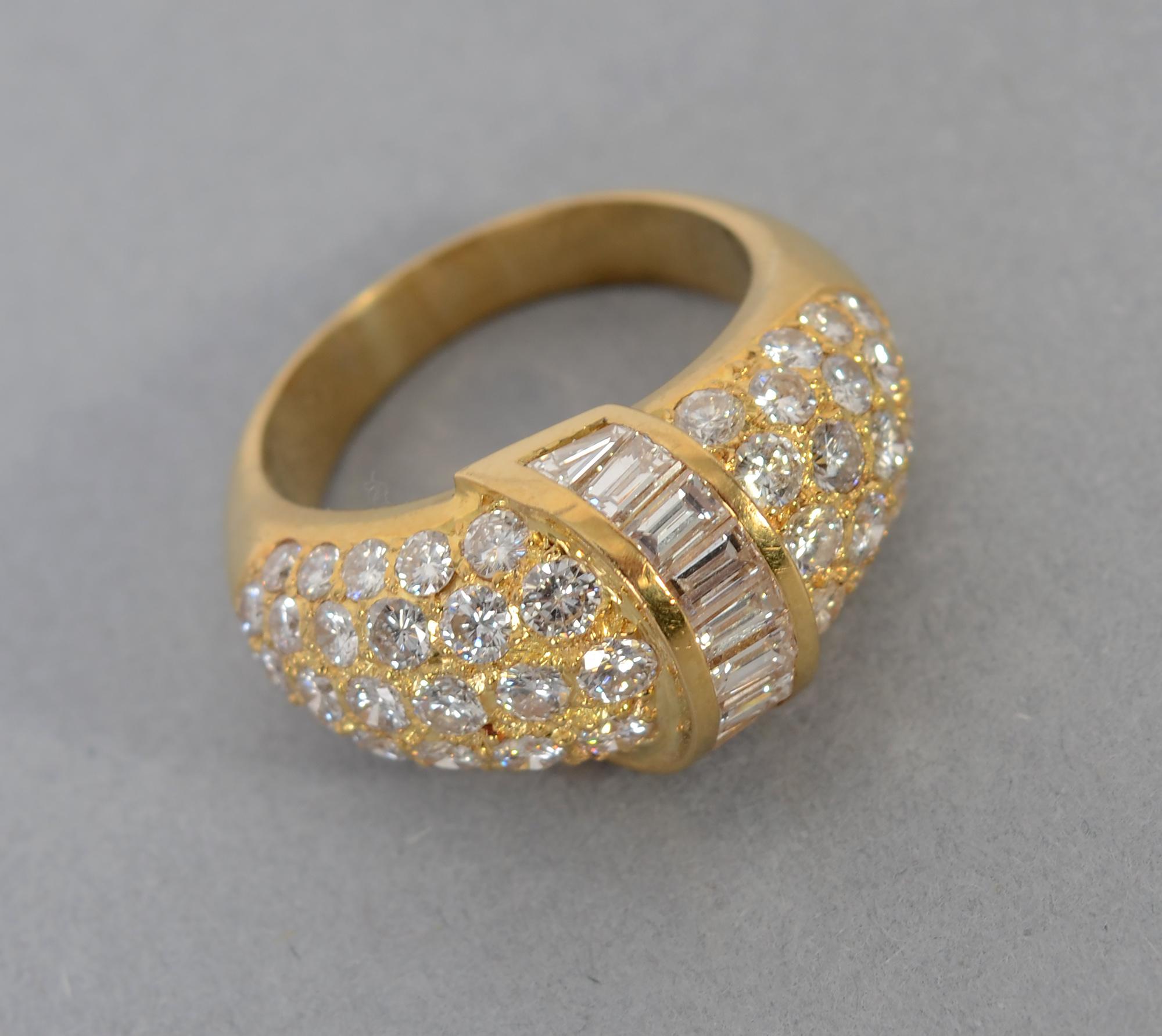 Elegant 18 karat gold cocktail ring with 60 diamonds weighing a total of approximately 3.5 carats. Baguette cut stones overlap a domed band of round brilliants. 
The ring is size 7 3/4 but can easily be sized up or down.
